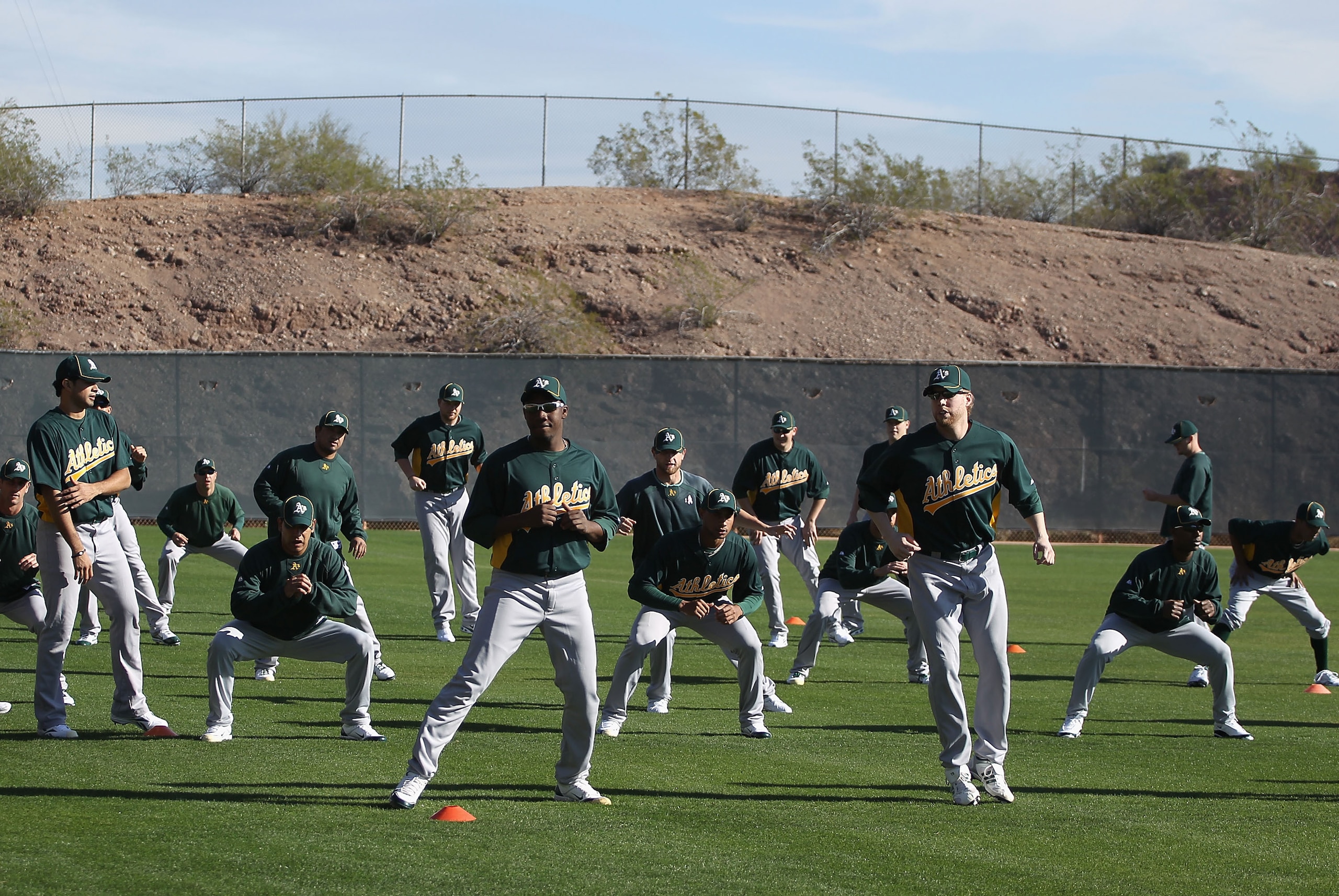 PHOENIX, AZ - FEBRUARY 16:  Pitchers for the Oakland Athletics warm up during a MLB spring training practice at Phoenix Municipal Stadium on February 16, 2011 in Phoenix, Arizona.  (Photo by Christian Petersen/Getty Images)