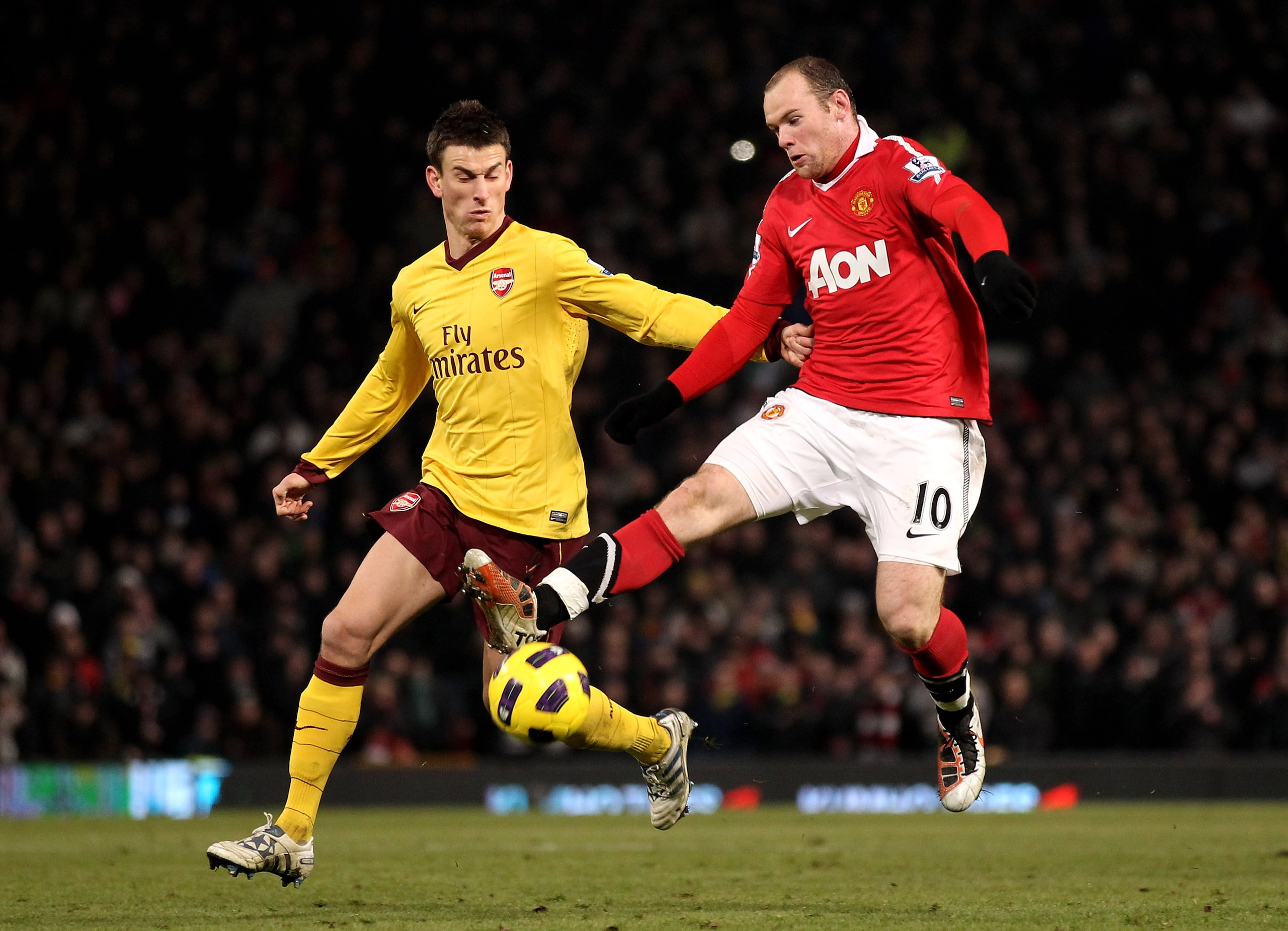 MANCHESTER, ENGLAND - DECEMBER 13:  Wayne Rooney of Manchester United tangles with Laurent Koscielny of Arsenal during the Barclays Premier League match between Manchester United and Arsenal at Old Trafford on December 13, 2010 in Manchester, England.  (P