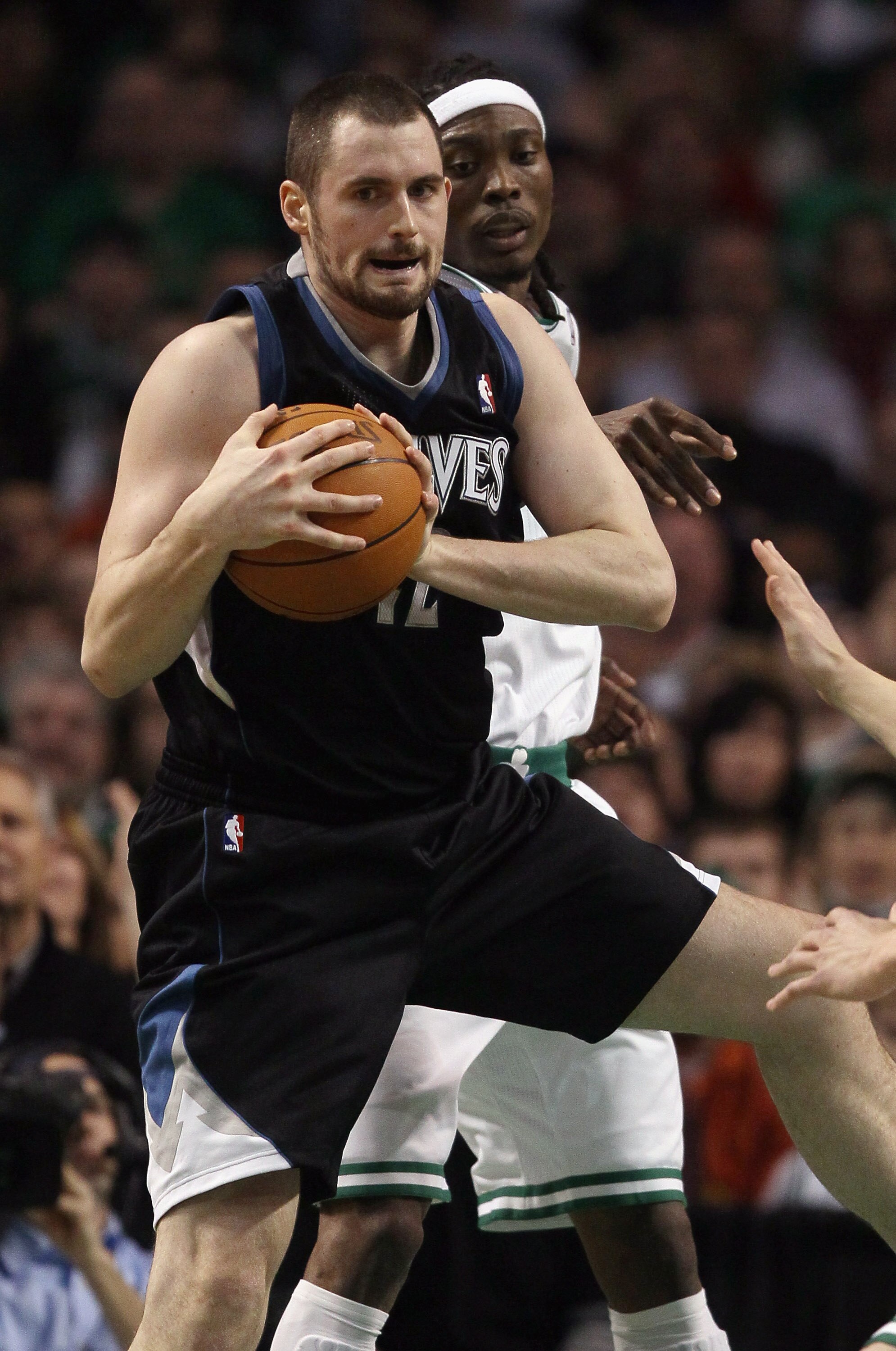 BOSTON, MA - JANUARY 03:  Kevin Love #42 of the Minnesota Timberwolves grabs the rebound before Marquis Daniels #8 of the Boston Celtics on January 3, 2011 at the TD Garden in Boston, Massachusetts. NOTE TO USER: User expressly acknowledges and agrees tha