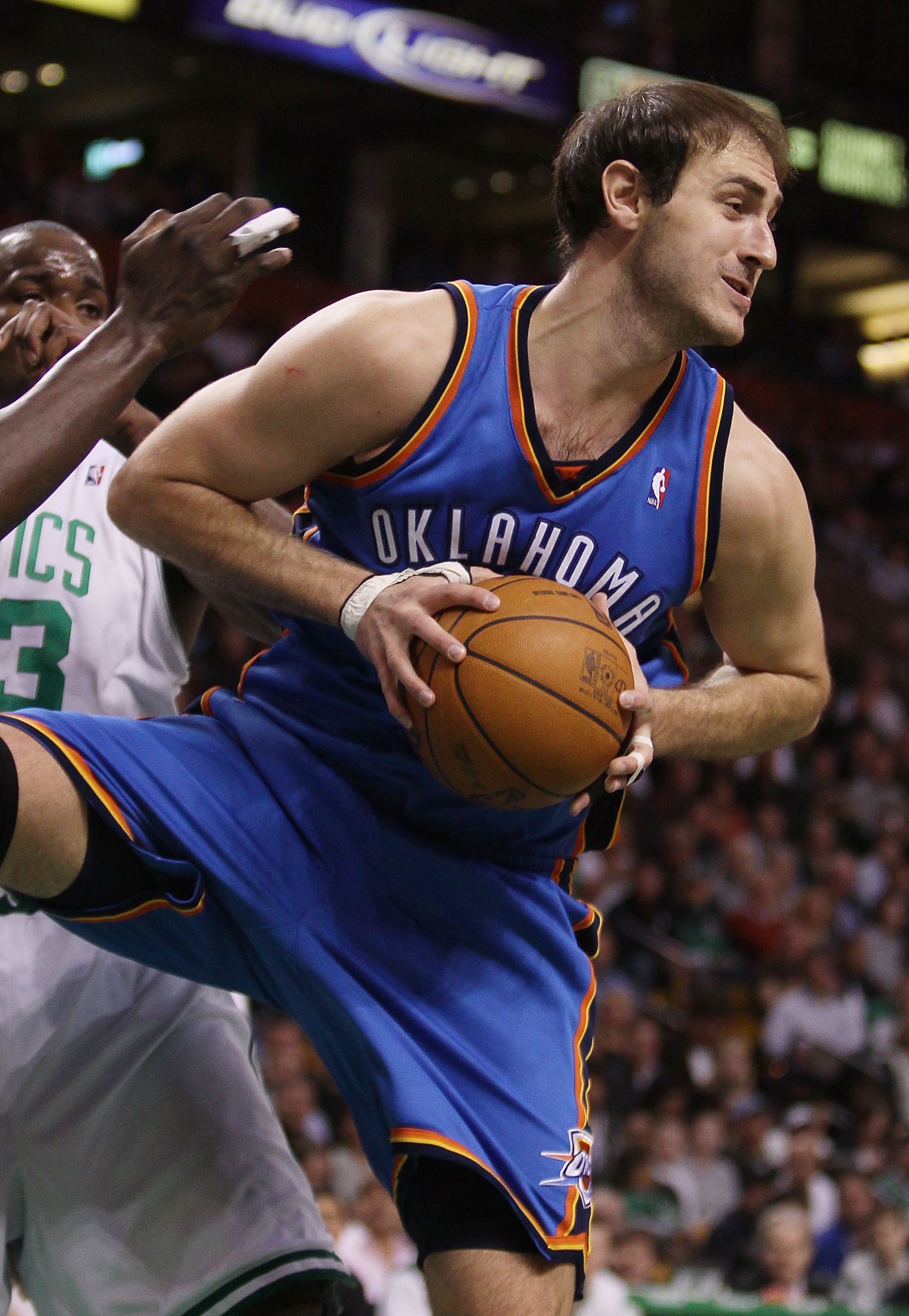 BOSTON - MARCH 31: Nenad Krstic #12 of the Oklahoma City Thunder grabs the rebound in the first quarter against the Boston Celtics on March 31, 2010 at the TD Garden in Boston, Massachusetts. NOTE TO USER: User expressly acknowledges and agrees that, by BOSTON - MARCH 31: Nenad Krstic #12 of the Oklahoma City Thunder grabs the rebound in the first quarter against the Boston Celtics on March 31, 2010 at the TD Garden in Boston, Massachusetts. NOTE TO USER: User expressly acknowledges and agrees that, by