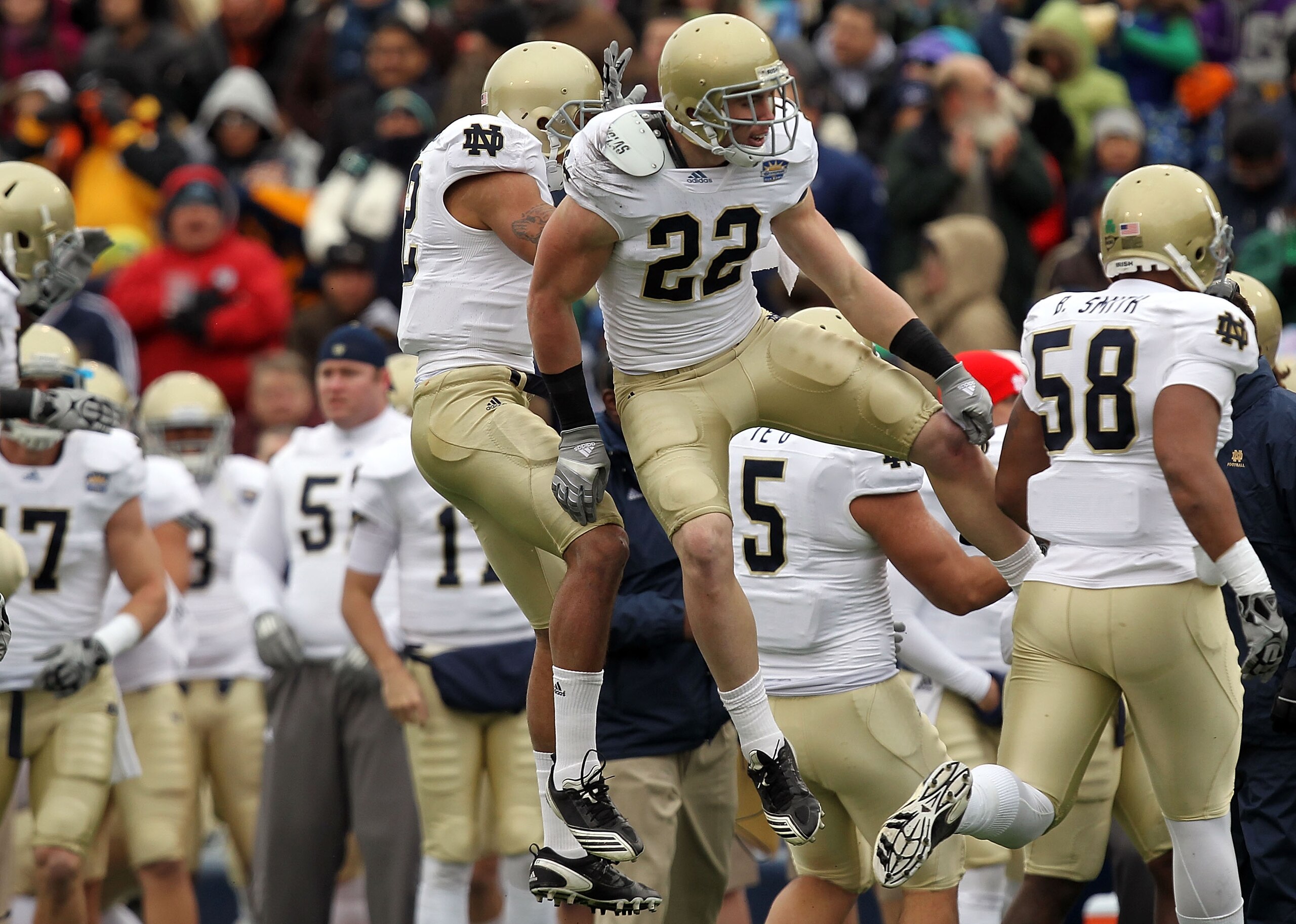 EL PASO, TX - DECEMBER 30:  Safety Harrison Smith #22 celebrates a pass interception with Robert Blanton #12 of the Notre Dame Fighting Irish during play against the Miami Hurricanes at Sun Bowl on December 30, 2010 in El Paso, Texas.  (Photo by Ronald Ma