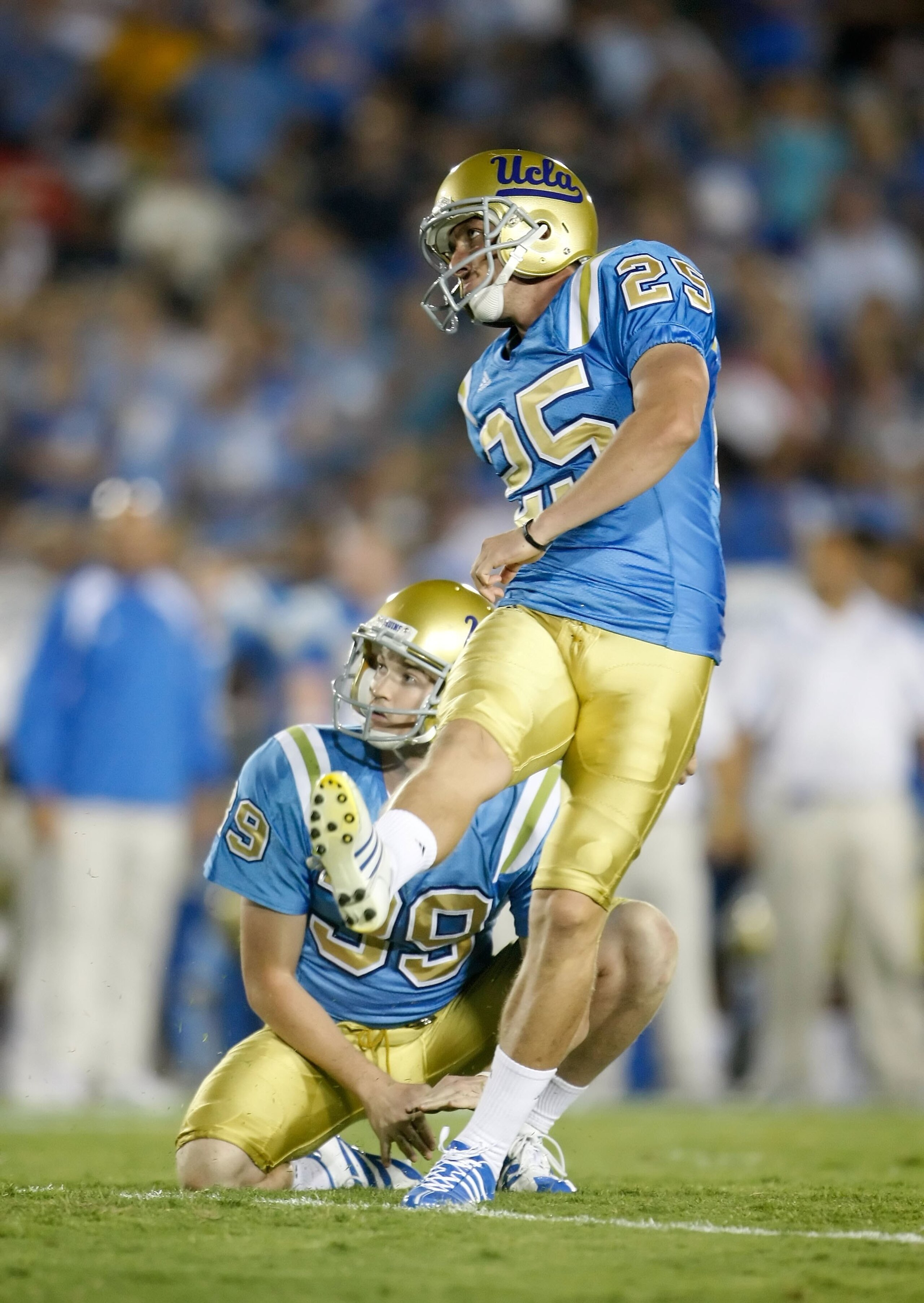 PASADENA, CA - SEPTEMBER 19:  Kai Forbath #25 of the UCLA Bruins kicks as Danny Rees #39 holds against the Kansas State Wildcats at the Rose Bowl on September 19, 2009 in Pasadena, California. UCLA defeated Kansas State 23-9.  (Photo by Jeff Gross/Getty I