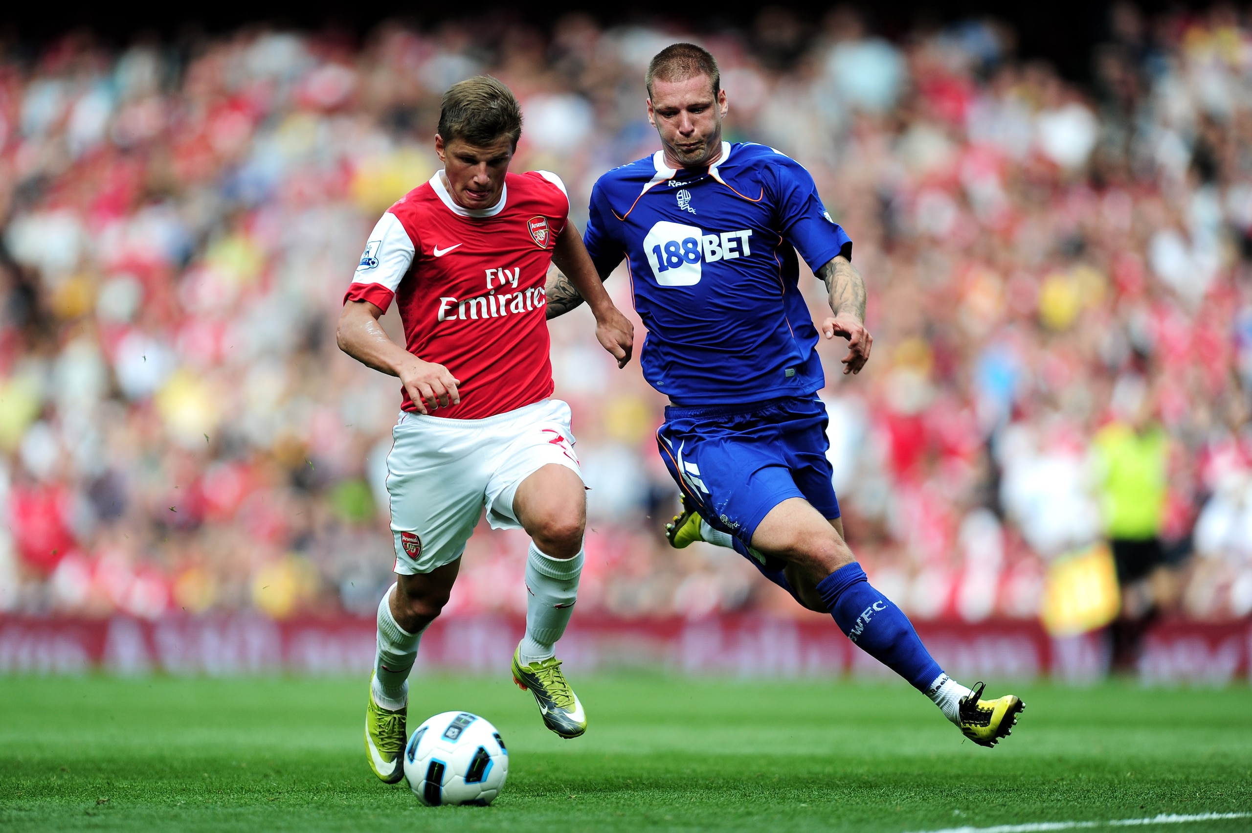 LONDON, ENGLAND - SEPTEMBER 11:  Andrei Arshavin of Arsenal is tackled by Gretar Steinsson of Bolton during the Barclays Premier League match between Arsenal and Bolton Wanderers at The Emirates Stadium on September 11, 2010 in London, England.  (Photo by