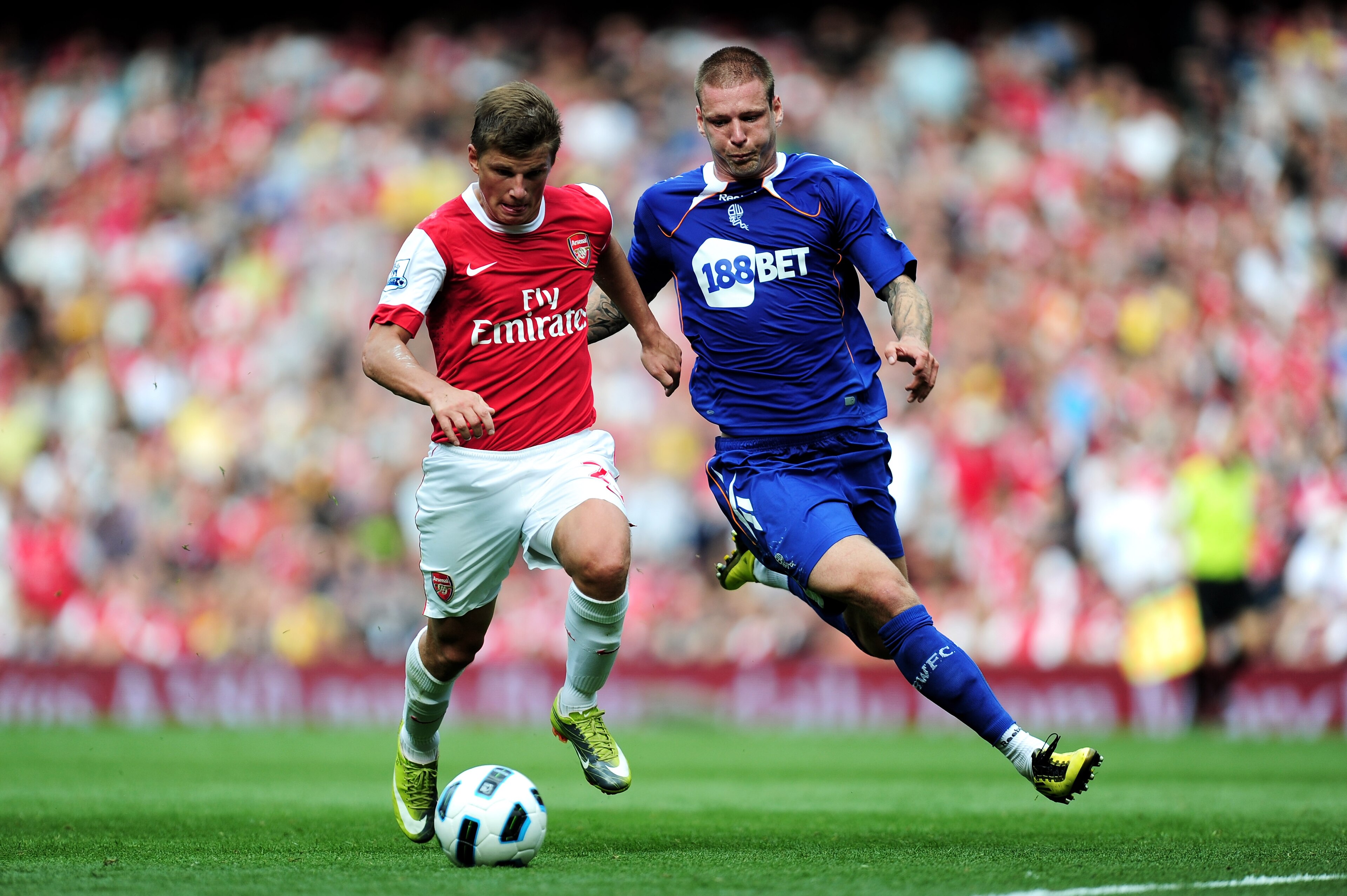LONDON, ENGLAND - SEPTEMBER 11:  Andrei Arshavin of Arsenal is tackled by Gretar Steinsson of Bolton during the Barclays Premier League match between Arsenal and Bolton Wanderers at The Emirates Stadium on September 11, 2010 in London, England.  (Photo by