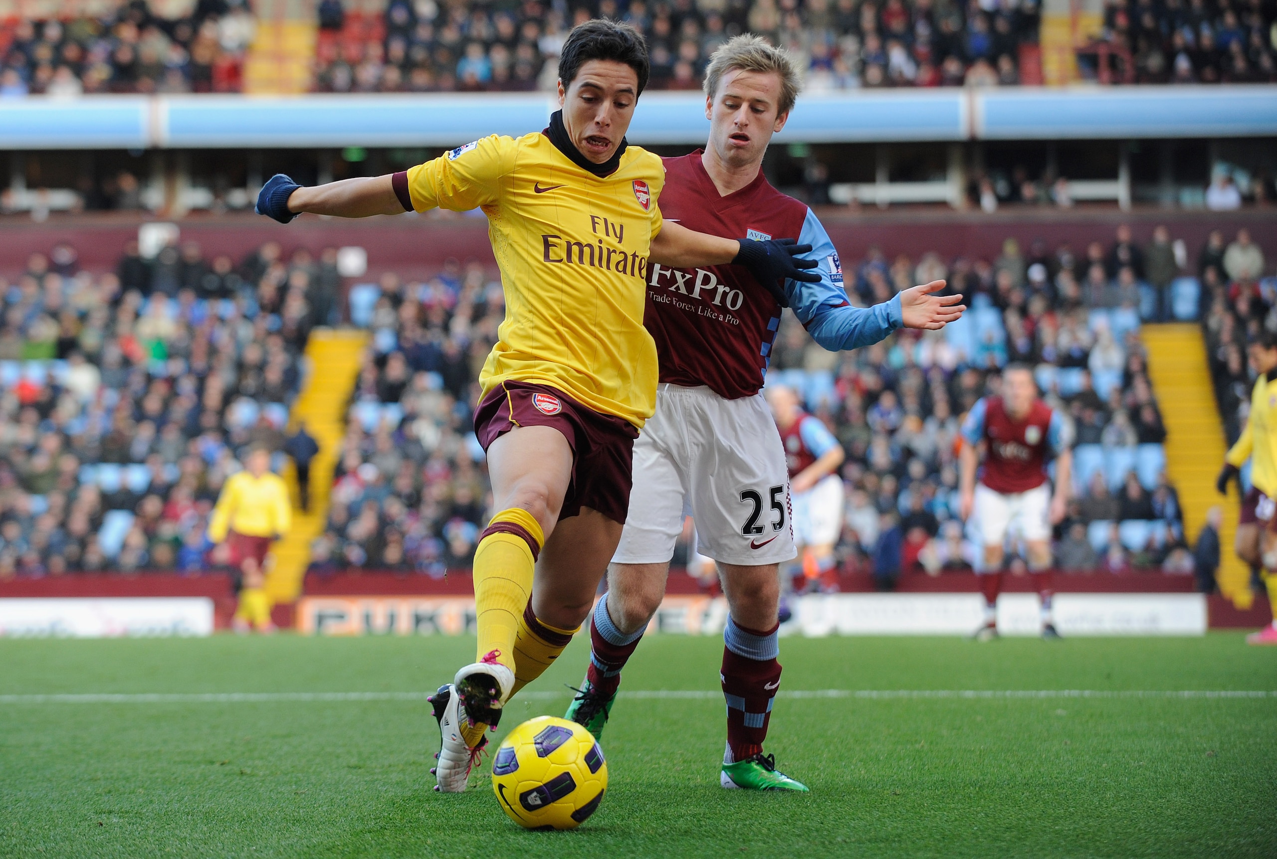 BIRMINGHAM, ENGLAND - NOVEMBER 27:  Samir Nasri of Arsenal battles Barry Bannan of Aston Villa during the Barclays Premier League match between Aston Villa and Arsenal at Villa Park on November 27, 2010 in Birmingham, England.  (Photo by Michael Regan/Get