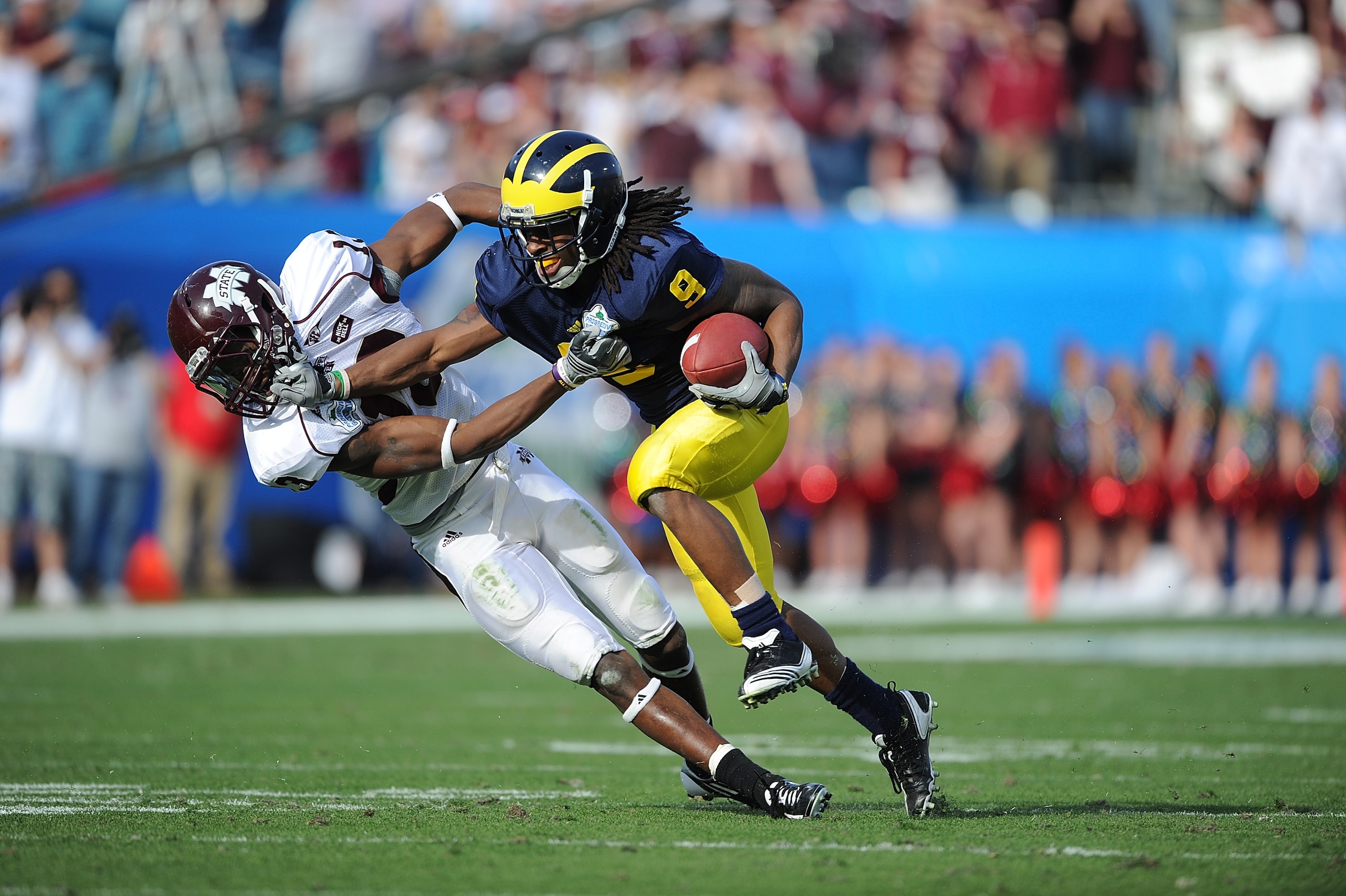 JACKSONVILLE, FL - JANUARY 01:  Martavious Odoms #9 of the Michigan Wolverines is tackled by Johnthan Banks of #13 of the Mississippi State Bulldogs during the Gator Bowl at EverBank Field on January 1, 2011 in Jacksonville, Florida  (Photo by Rick Dole/G