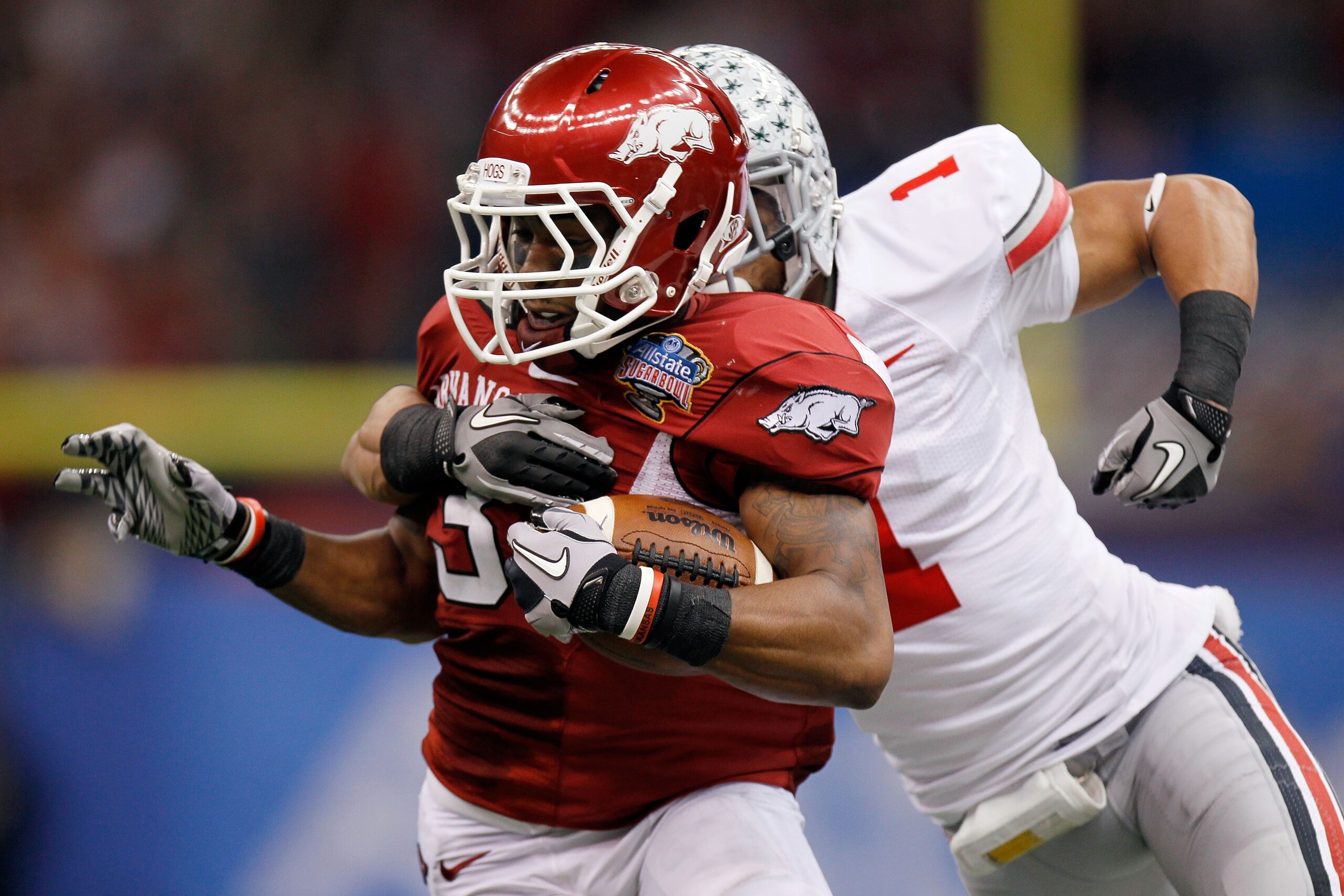 NEW ORLEANS, LA - JANUARY 04:  Joe Adams #3 of the Arkansas Razorbacks runs after a catch against Devon Torrence #1 of the Ohio State Buckeyes in the second half during the Allstate Sugar Bowl at the Louisiana Superdome on January 4, 2011 in New Orleans,
