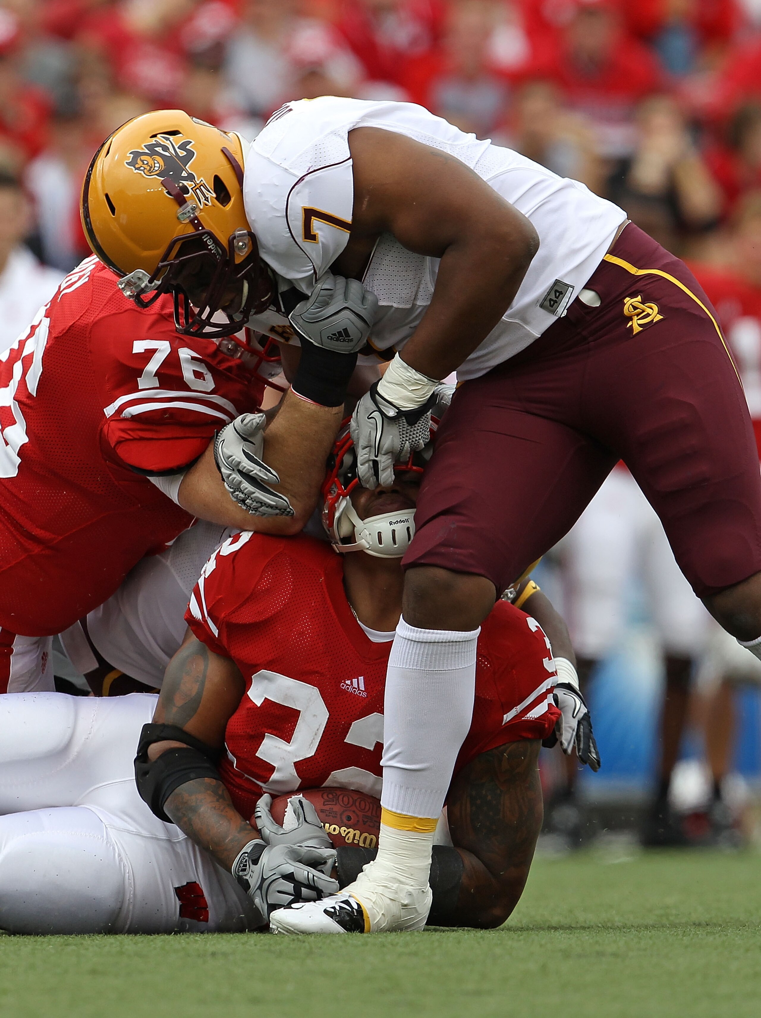 MADISON, WI - SEPTEMBER 18: John Clay #32 of the Wisconsin Badgers is tackled by the fask mask by Vontaze Burfict #7 of the Arizona State Sun Devils at Camp Randall Stadium on September 18, 2010 in Madison, Wisconsin. (Photo by Jonathan Daniel/Getty Image