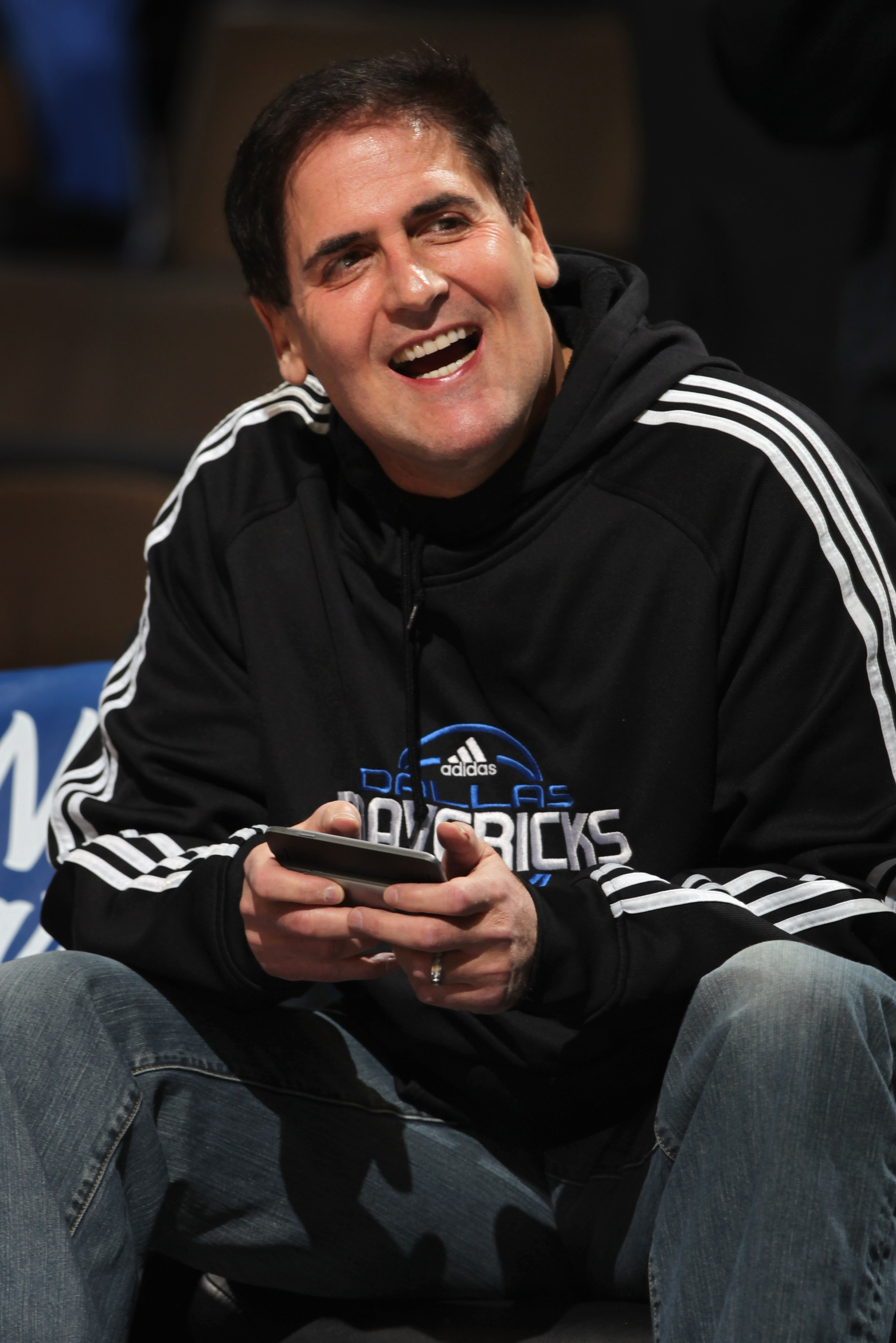 DENVER, CO - FEBRUARY 10:  Mark Cuban, owner of the Dallas Mavericks, uses a personal electonic device as he sits on the bench during warm ups against the Denver Nuggets during NBA action at the Pepsi Center on February 10, 2011 in Denver, Colorado. The N