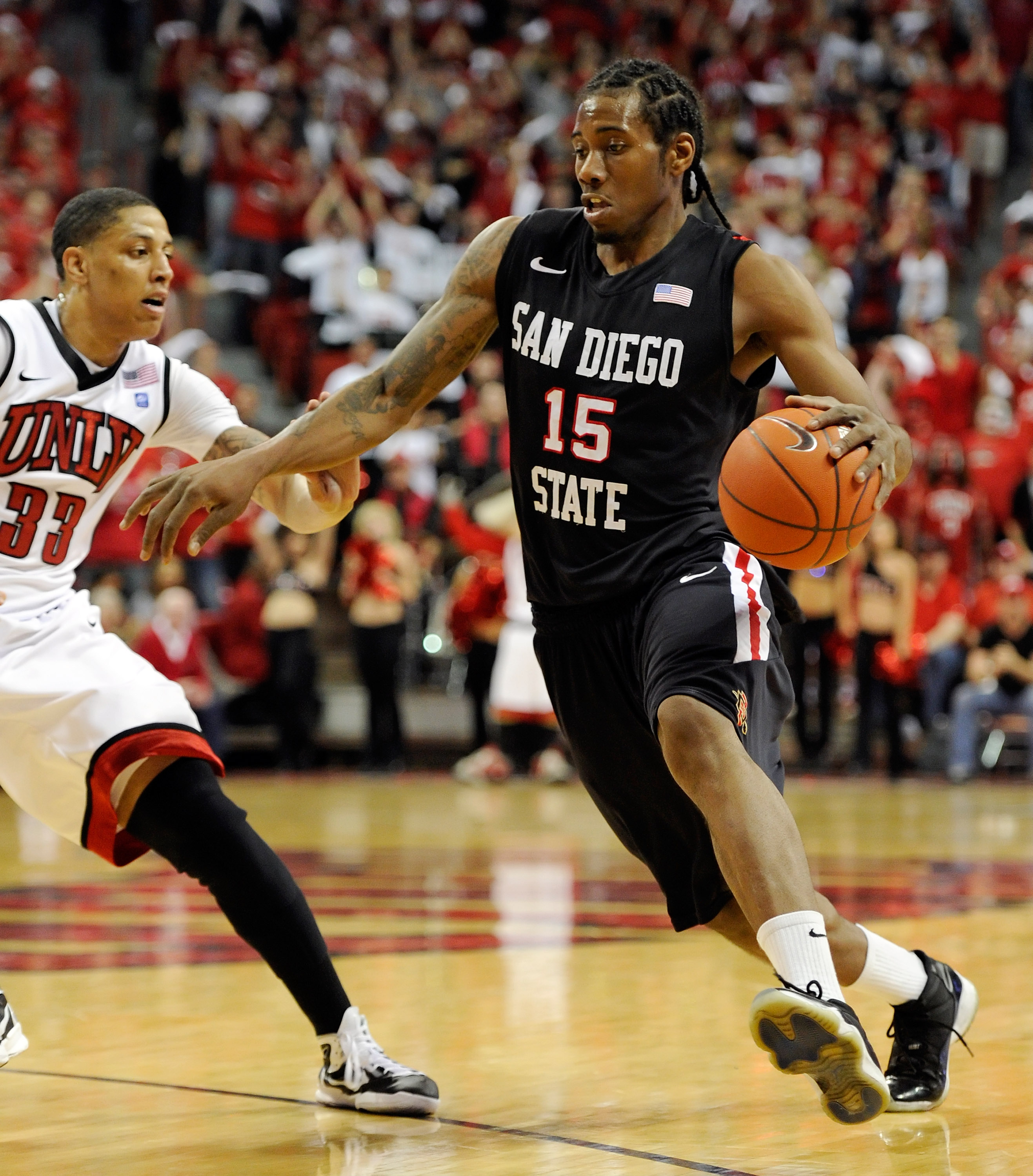 LAS VEGAS, NV - FEBRUARY 12:  Kawhi Leonard #15 of the San Diego State Aztecs drives against Tre'Von Willis #33 of the UNLV Rebels during their game at the Thomas & Mack Center February 12, 2011 in Las Vegas, Nevada. San Diego State won 63-57.  (Photo by