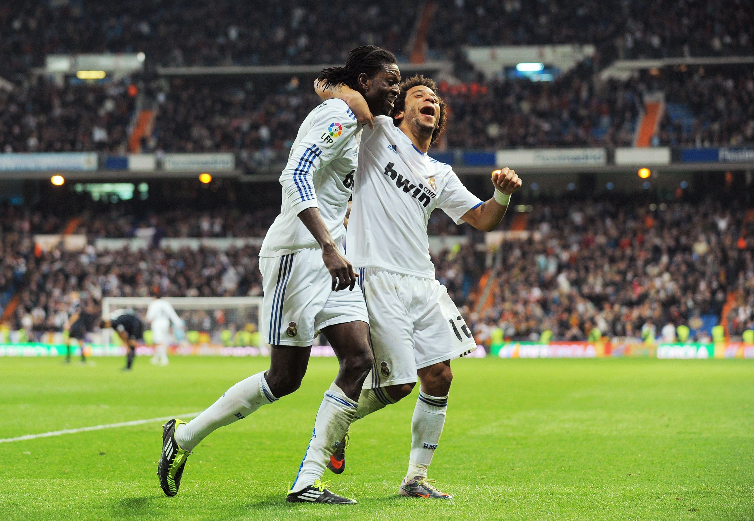 MADRID, SPAIN - FEBRUARY 06:  Emmanuel Adebayor (L) of Real Madrid celebrates with Marcelo after scoring Real's fourth goal during the La Liga match between Real Madrid and Real Sociedad at Estadio Santiago Bernabeu on February 6, 2011 in Madrid, Spain.