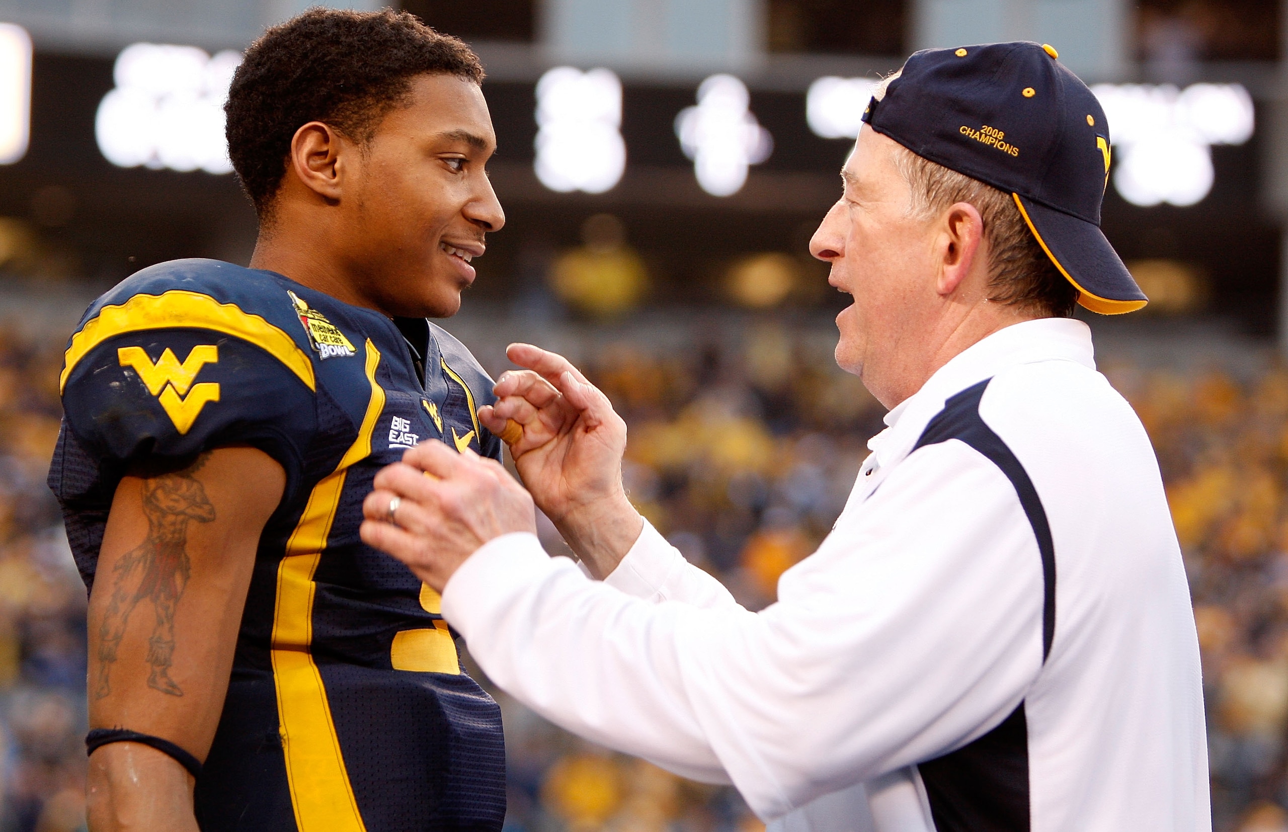 CHARLOTTE, NC - DECEMBER 27:  Head coach Bill Stewart of the West Virginia Mountaineers celebrates with his quarterback Pat White #5 after their 31-30 victory over the North Carolina Tar Heels at Bank of America Stadium on December 27, 2008 in Charlotte,