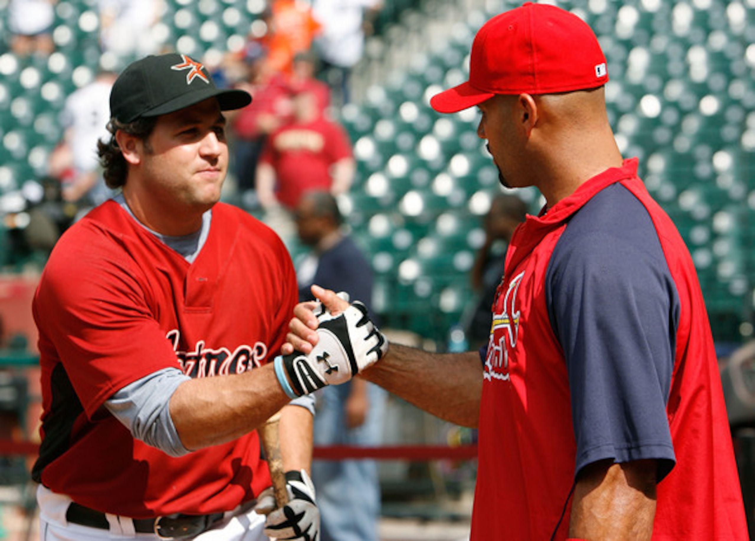 Berkman (left) is in store for many a handshake with Albert Pujols this season.
