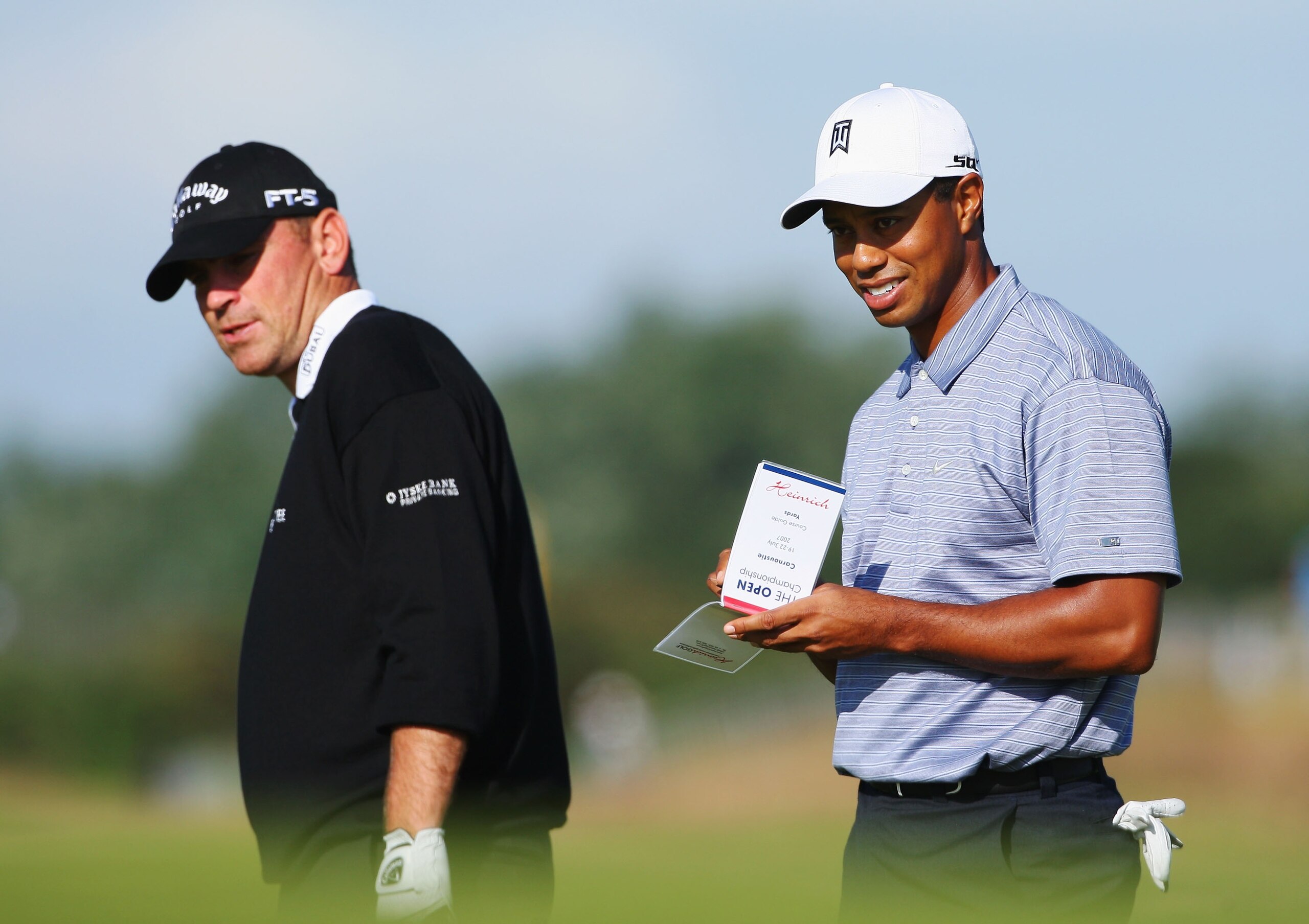 CARNOUSTIE, UNITED KINGDOM - JULY 17:  Tiger Woods (R) of the United States of America and Thomas Bjorn (L) of Denmark line up their putts on the 16th hole green during previews to The 136th Open Championship at the Carnoustie Golf Club on July 17, 2007 i