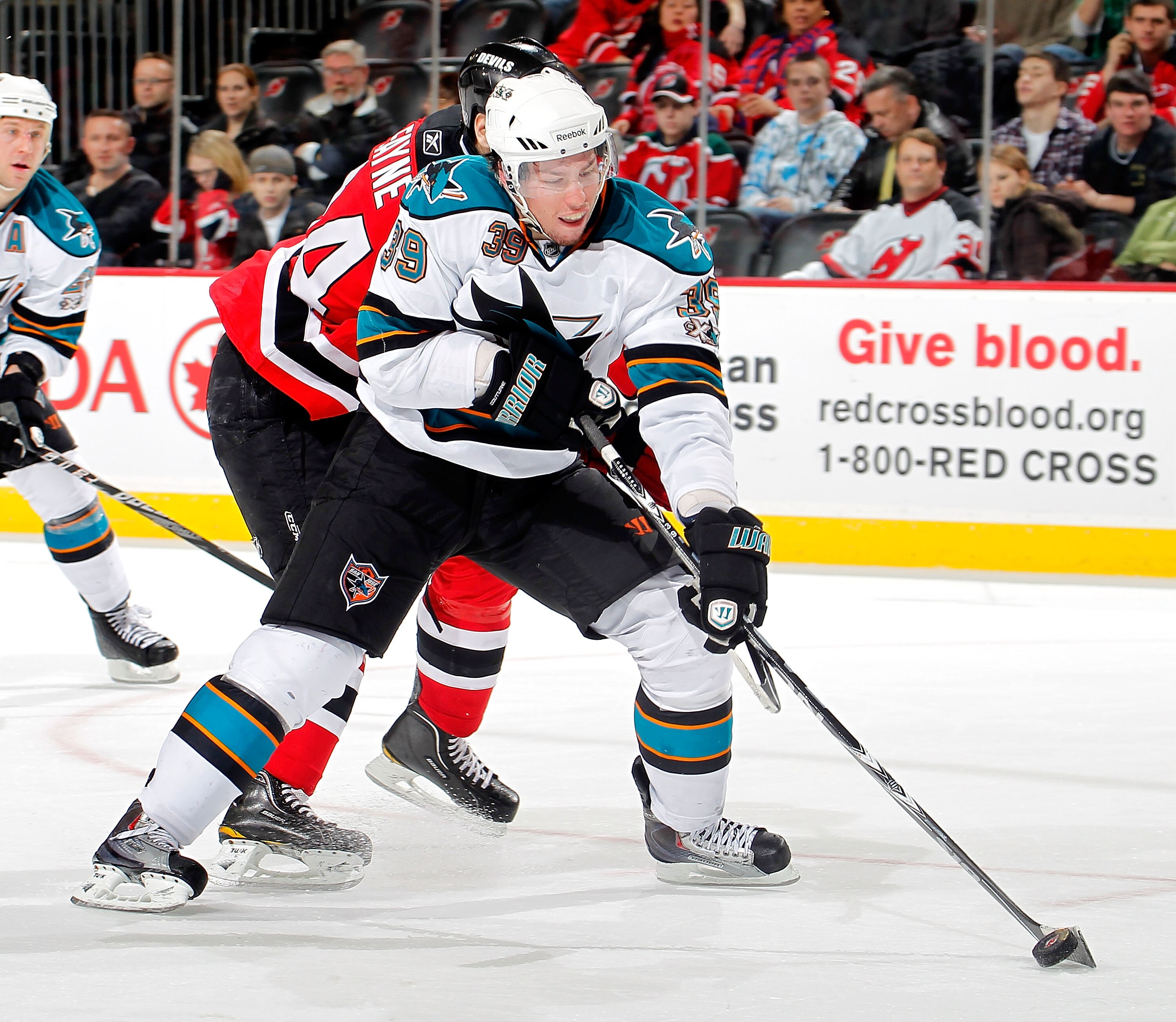 NEWARK, NJ - FEBRUARY 11: Logan Couture #39 of the San Jose Sharks skates during an NHL hockey game against the New Jersey Devils on February 11, 2011 at the Prudential Center in Newark, New Jersey. (Photo by Paul Bereswill/Getty Images)