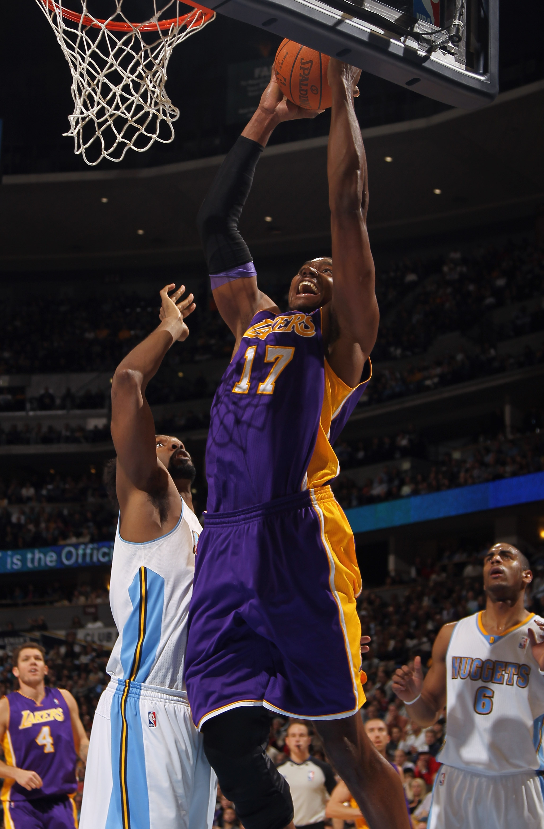 DENVER, CO - JANUARY 21:  Andrew Bynum #17 of the Los Angeles Lakers takes a shot against Nene #31 of the Denver Nuggets at the Pepsi Center on January 21, 2011 in Denver, Colorado. NOTE TO USER: User expressly acknowledges and agrees that, by downloading