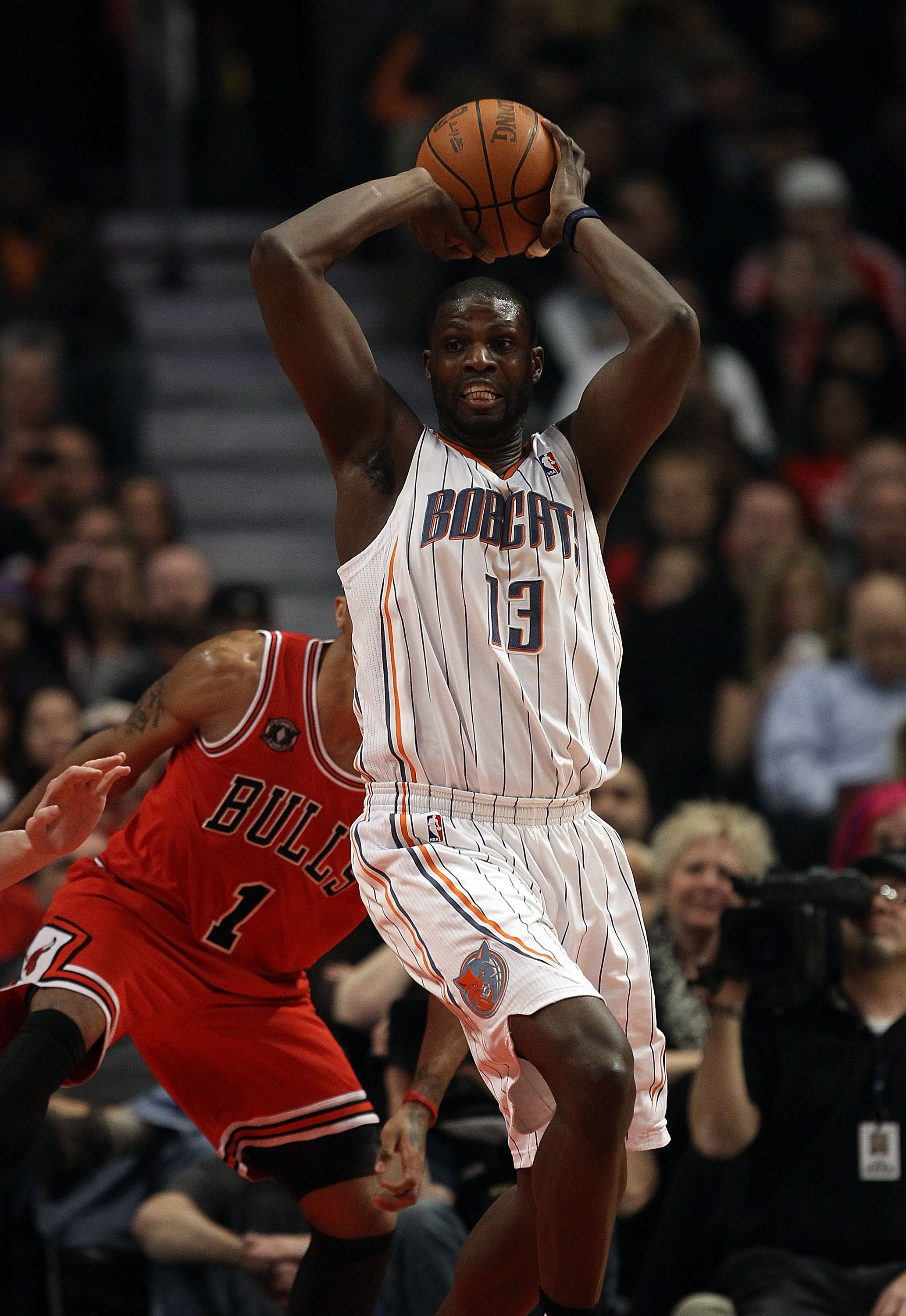 CHICAGO, IL - FEBRUARY 15: Nazr Mohammed #13 of the Charlotte Bobcats controls a rebound in front of Derrick Rose #1 of the Chicago Bulls at the United Center on February 15, 2011 in Chicago, Illinois. The Bulls defeated the Bobcats 106-94. NOTE TO USER: 