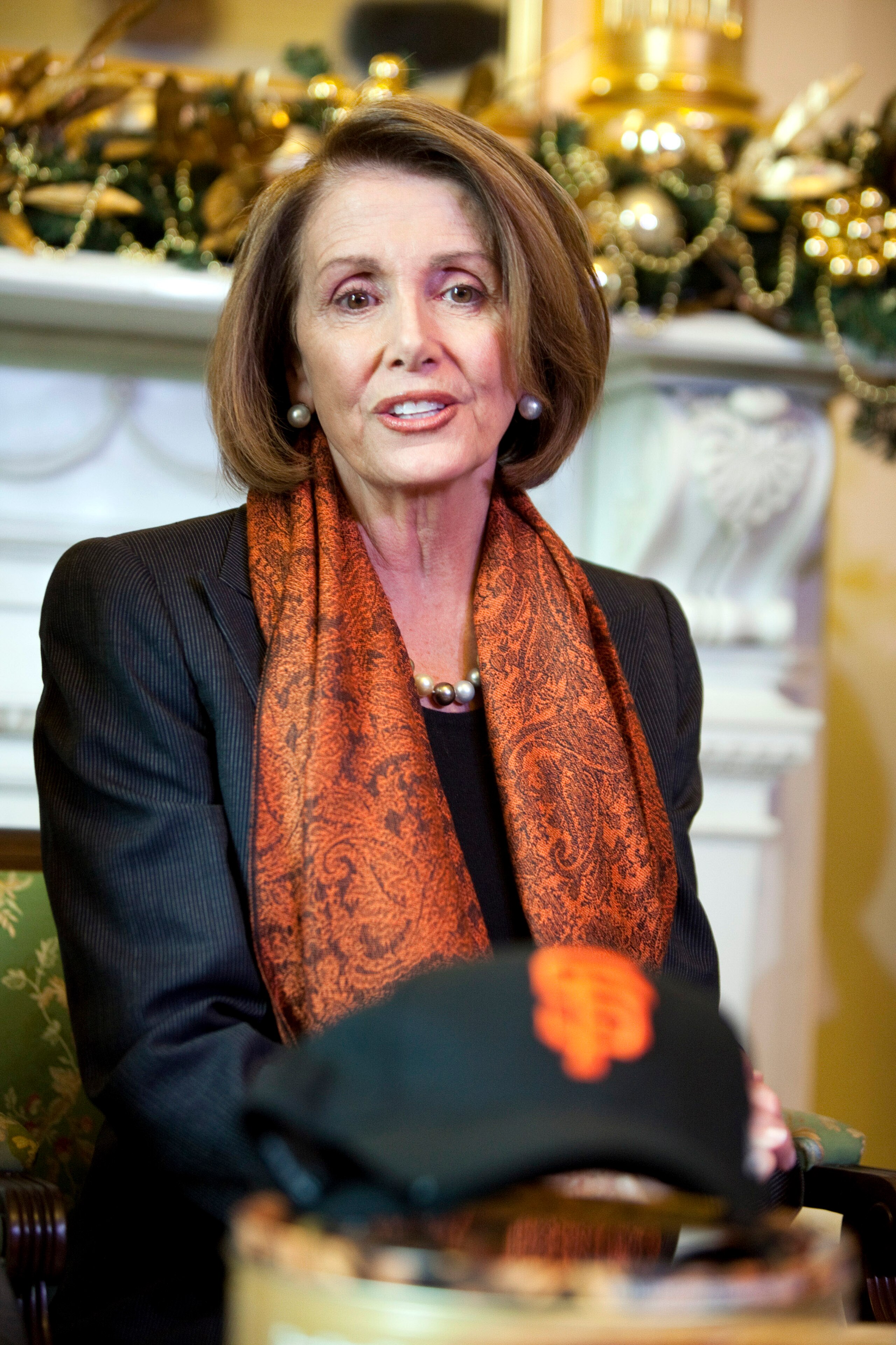 WASHINGTON - DECEMBER 2:  Speaker of the House Speaker Rep. Nancy Pelosi (D-CA) speaks as she received pecan pies from Rep. Joe Barton (R-TX) and a giant Hershey bar from Rep. Arlen Specter (D-PA) to settle a bet after the San Francisco Giants won the Wor