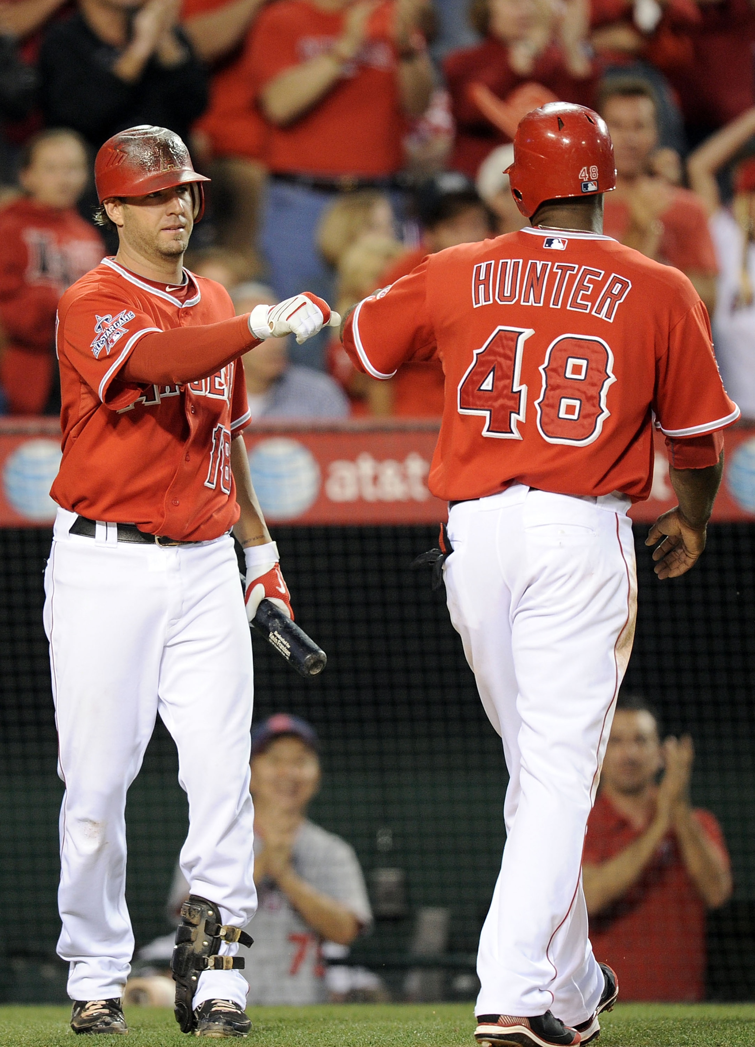ANAHEIM, CA - JULY 02:  Kevin Frandsen #18 celebrates the run of Torii Hunter #48 of the Los Angeles Angels against the Kansas City Royals for a 1-0 lead during the fourth inning at Angel Stadium on July 2, 2010 in Anaheim, California.  (Photo by Harry Ho