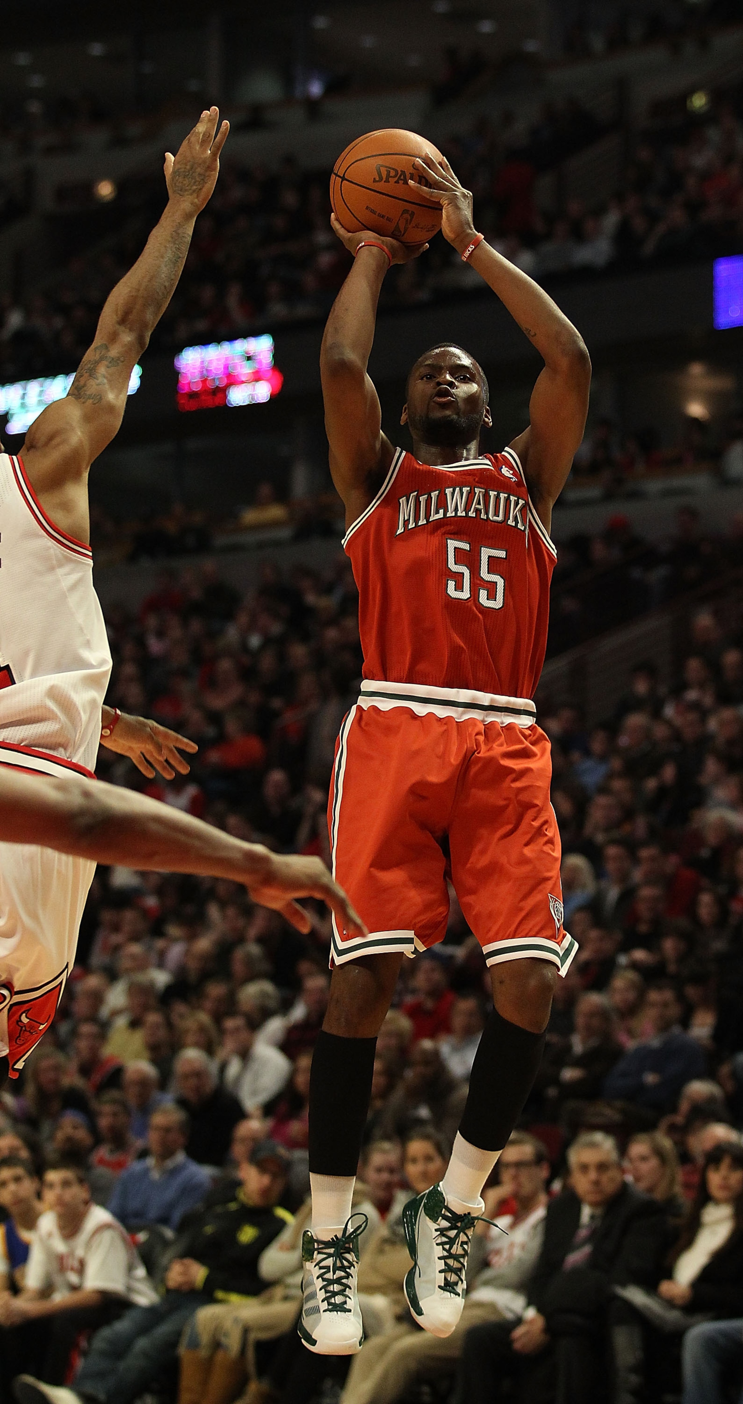 CHICAGO, IL - DECEMBER 28: Keyon Dooling #55 of the Milwaukee Bucks puts up a shot against Derrick Rose #1 of the Chicago Bulls at the United Center on December 28, 2010 in Chicago, Illinois. The Bulls defeated the Bucks 90-77. NOTE TO USER: User expressl