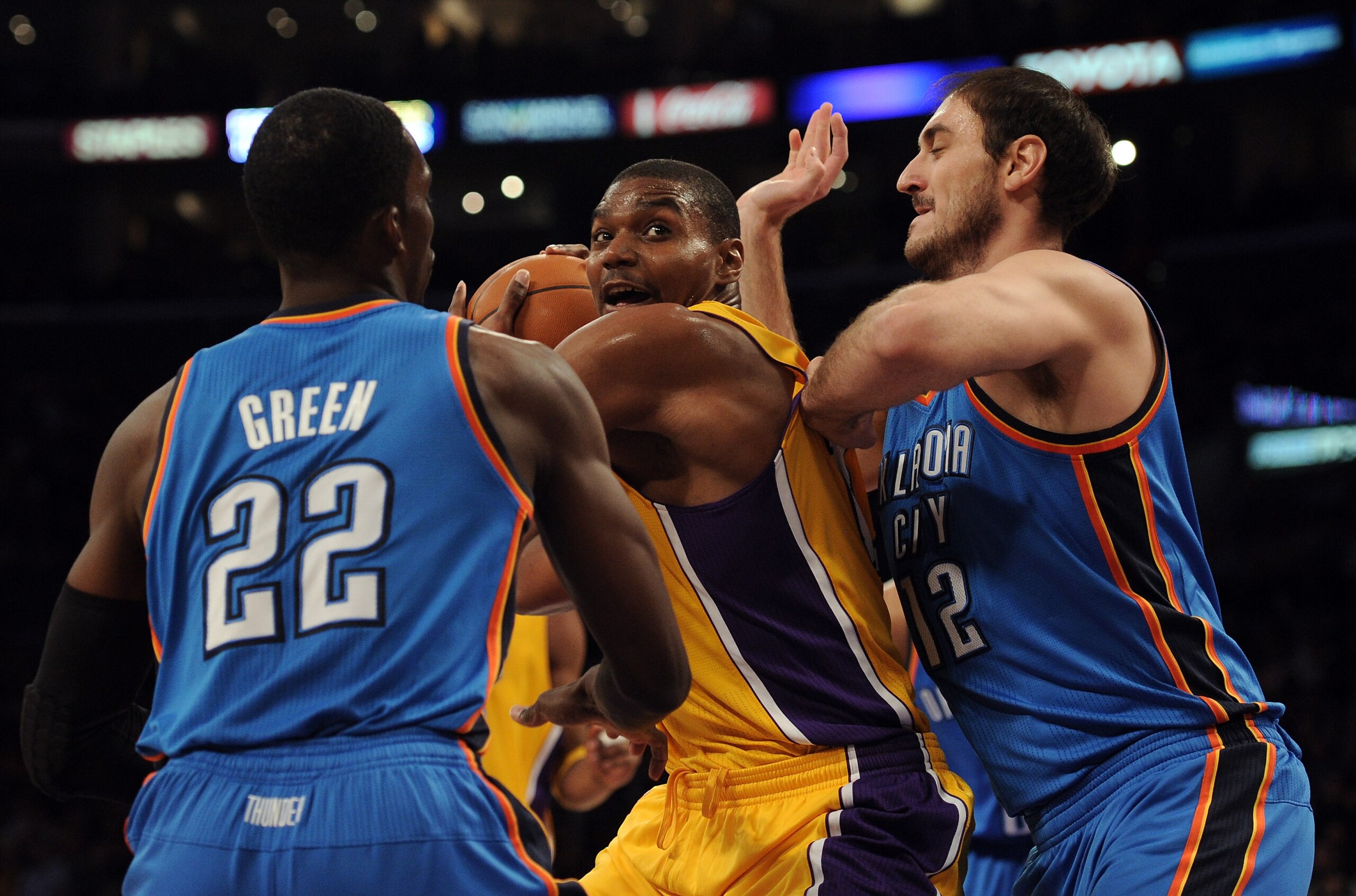 LOS ANGELES, CA - JANUARY 17:  Andew Bynum #17 of the Los Angeles Lakers looks for an opening between Nenad Kristic #12 and Jeff Green #22 of the Oklahoma City Thunder at the Staples Center on January 17, 2011 in Los Angeles, California.  (Photo by Harry