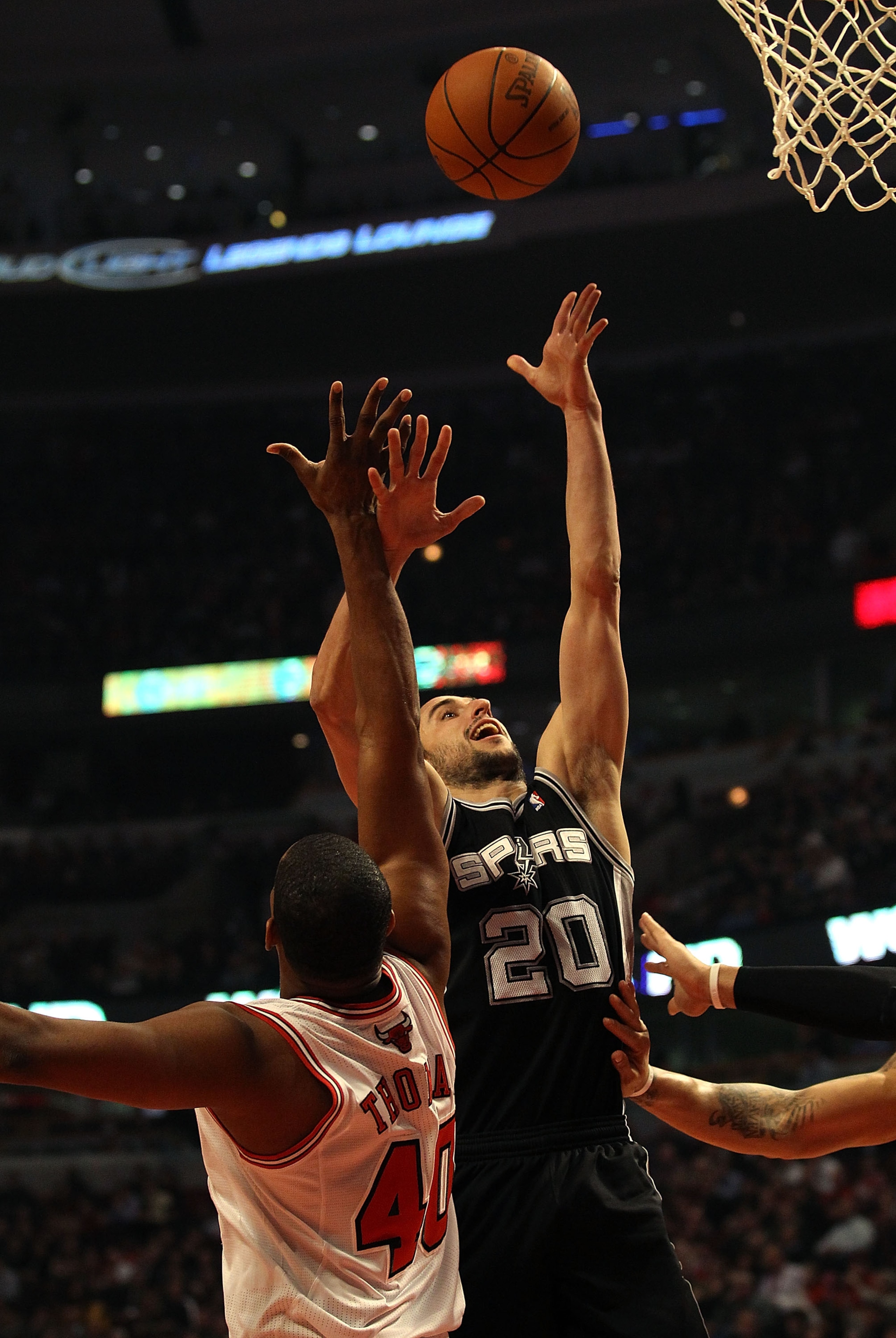 CHICAGO, IL - FEBRUARY 17: Manu Ginobili #20 of the San Antonio Spurs puts up a shot over Kurt Thomas #40 of the Chicago Bulls at the United Center on February 17, 2011 in Chicago, Illinois. NOTE TO USER: User expressly acknowledges and agrees that, by do