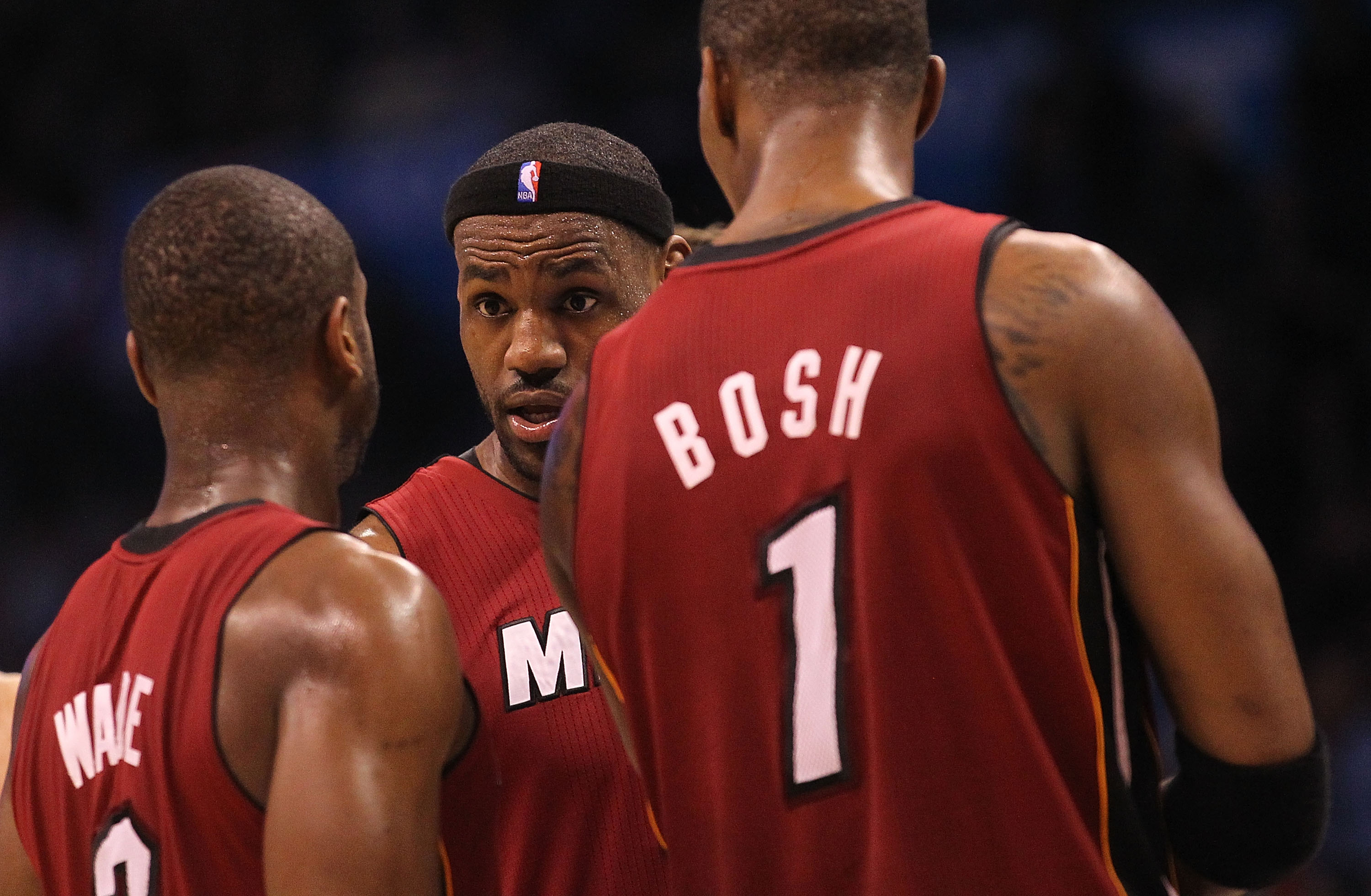 OKLAHOMA CITY, OK - JANUARY 30:  Forward LeBron James #6 talks with Dwyane Wade #3 and Chris Bosh #1 of the Miami Heat during play against the Oklahoma City Thunder at Ford Center on January 30, 2011 in Oklahoma City, Oklahoma.  NOTE TO USER: User express