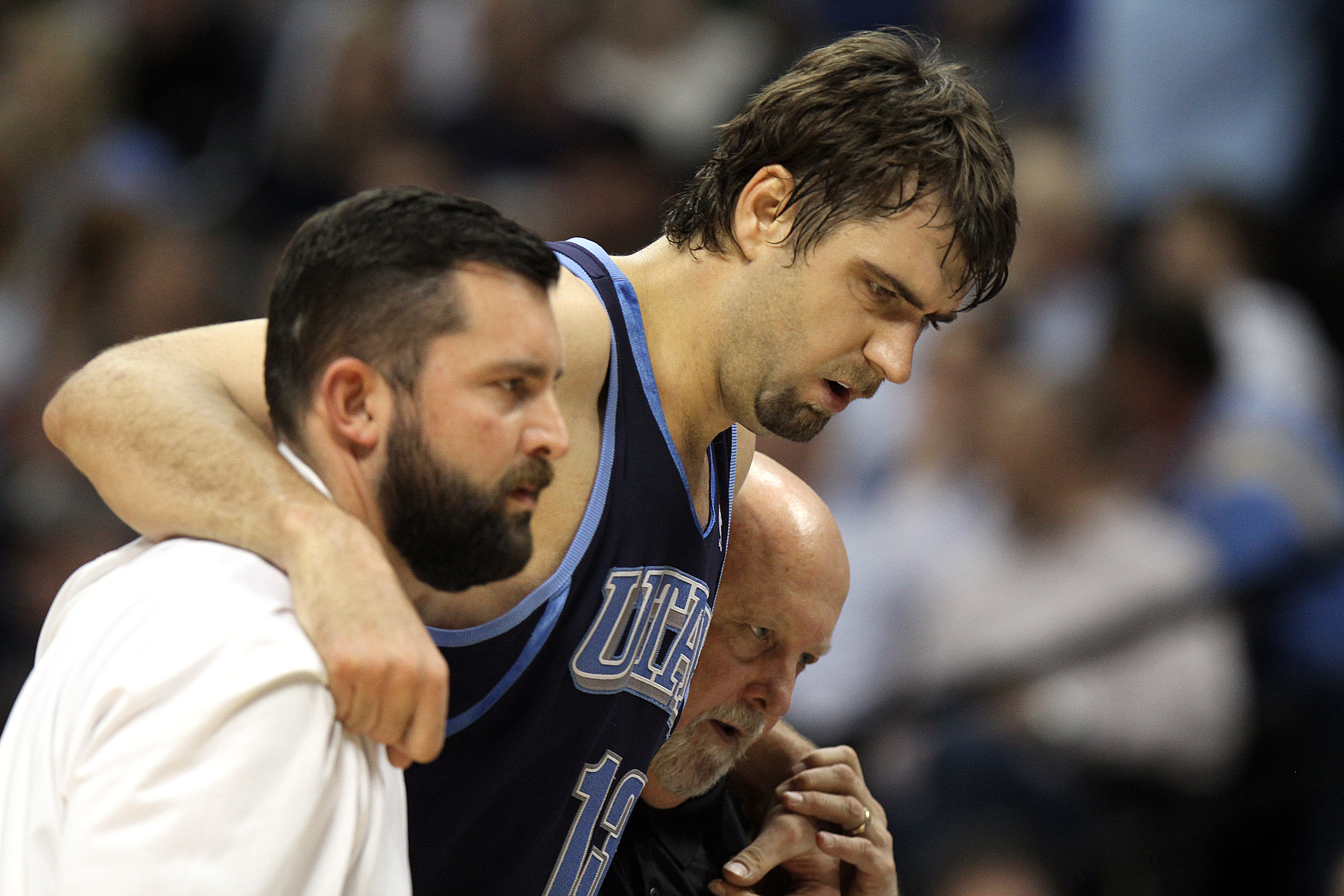DENVER, CO - APRIL 17 : Mehmet Okur #13 of the Utah Jazz is helped off the court by trainers after twisitng an ankle during the first half of Game One of the Western Conference Quarterfinals of the 2010 NBA Playoffs at the Pepsi Center on April 17, 2010 i