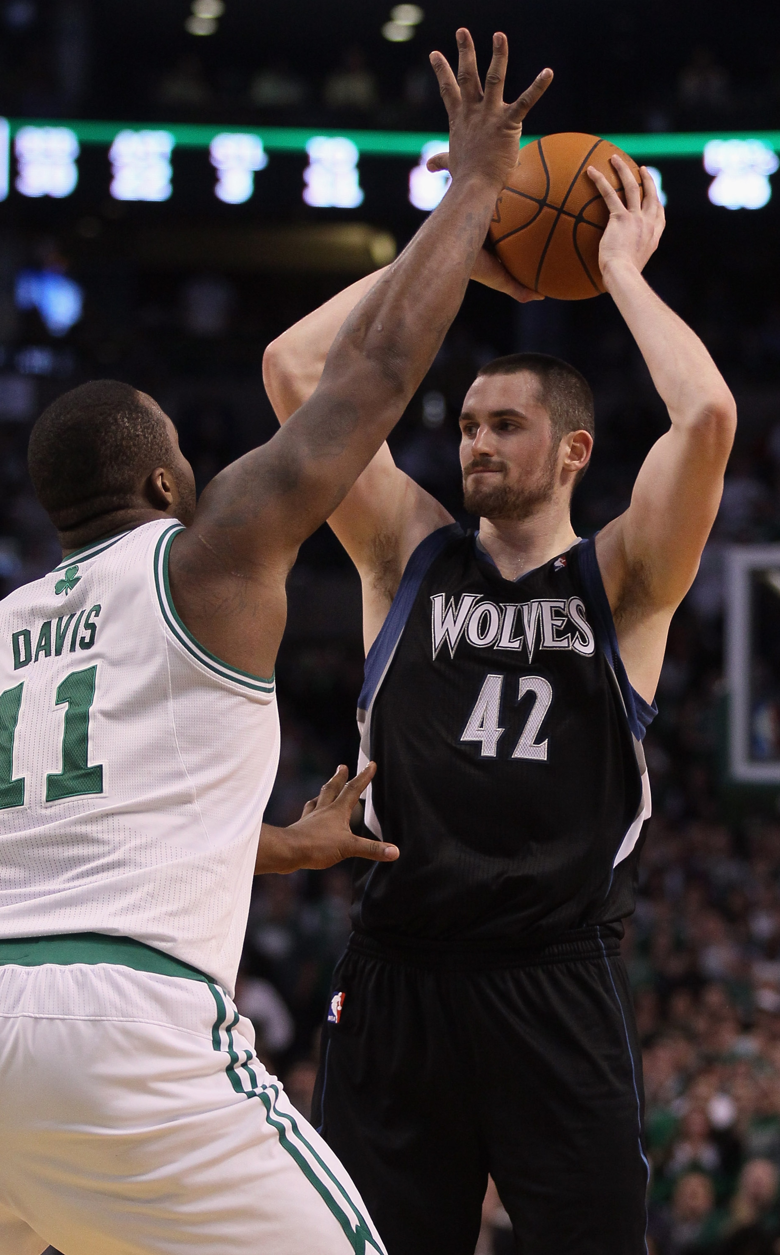 BOSTON, MA - JANUARY 03:  Kevin Love #42 of the Minnesota Timberwolves looks to pass as Glen Davis #11 of the Boston Celtics defends on January 3, 2011 at the TD Garden in Boston, Massachusetts. The Celtics defeated the Timberwolves 96-93. NOTE TO USER: U