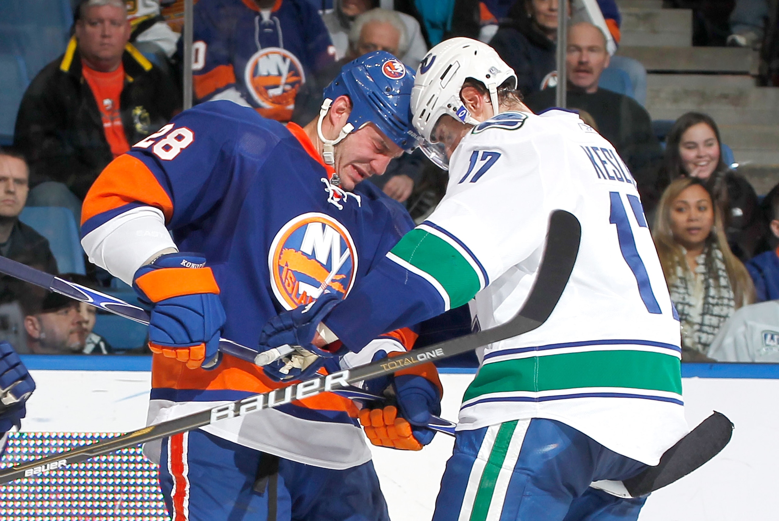 UNIONDALE, NY - JANUARY 11: Ryan Kesler #17 of the Vancouver Canucks butts heads with Zenon Konopka #28 of the New York Islanders during an NHL game at the Nassau Coliseum on January 11, 2011 in Uniondale, New York.  (Photo by Paul Bereswill/Getty Images)
