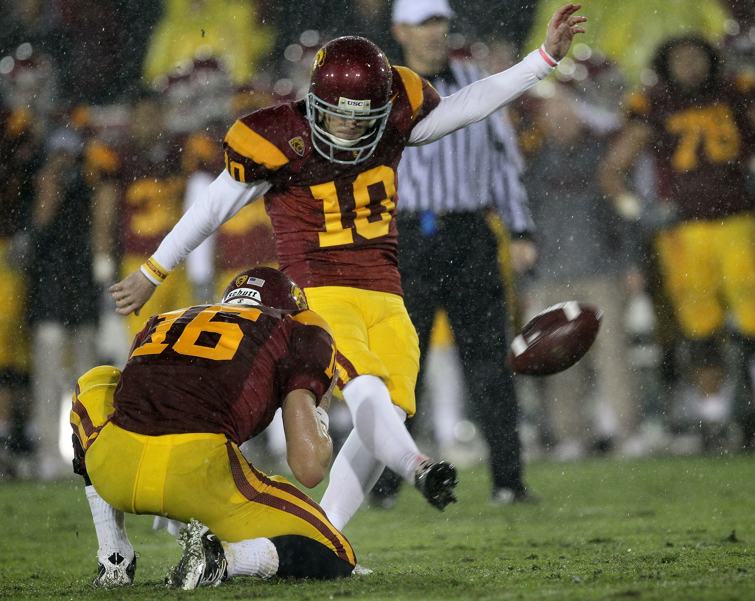LOS ANGELES - NOVEMBER 27: Kicker Joe Houston #10 of the USC Trojans makes a fourth quarter field goal out of the hold of Mitch Mustain #16 to give the Trojans a temporary lead against the Notre Dame Fighting Irish at the Los Angeles Memorial Coliseum on LOS ANGELES - NOVEMBER 27: Kicker Joe Houston #10 of the USC Trojans makes a fourth quarter field goal out of the hold of Mitch Mustain #16 to give the Trojans a temporary lead against the Notre Dame Fighting Irish at the Los Angeles Memorial Coliseum on
