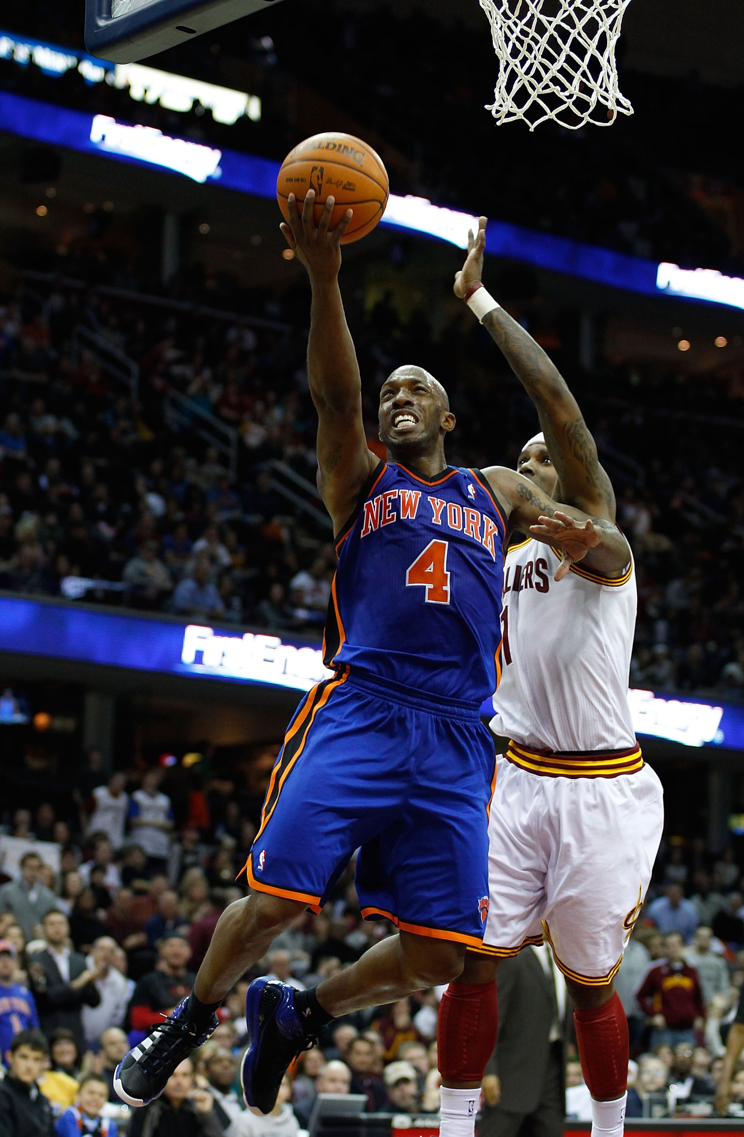 CLEVELAND - FEBRUARY 25: Chauncey Billups #4 of the New York Knicks drives to the hoop in front of Daniel Gibson #1 of the Cleveland Cavaliers during the game on February 25, 2011 at Quicken Loans Arena in Cleveland, Ohio. NOTE TO USER: User expressly a CLEVELAND - FEBRUARY 25: Chauncey Billups #4 of the New York Knicks drives to the hoop in front of Daniel Gibson #1 of the Cleveland Cavaliers during the game on February 25, 2011 at Quicken Loans Arena in Cleveland, Ohio. NOTE TO USER: User expressly a