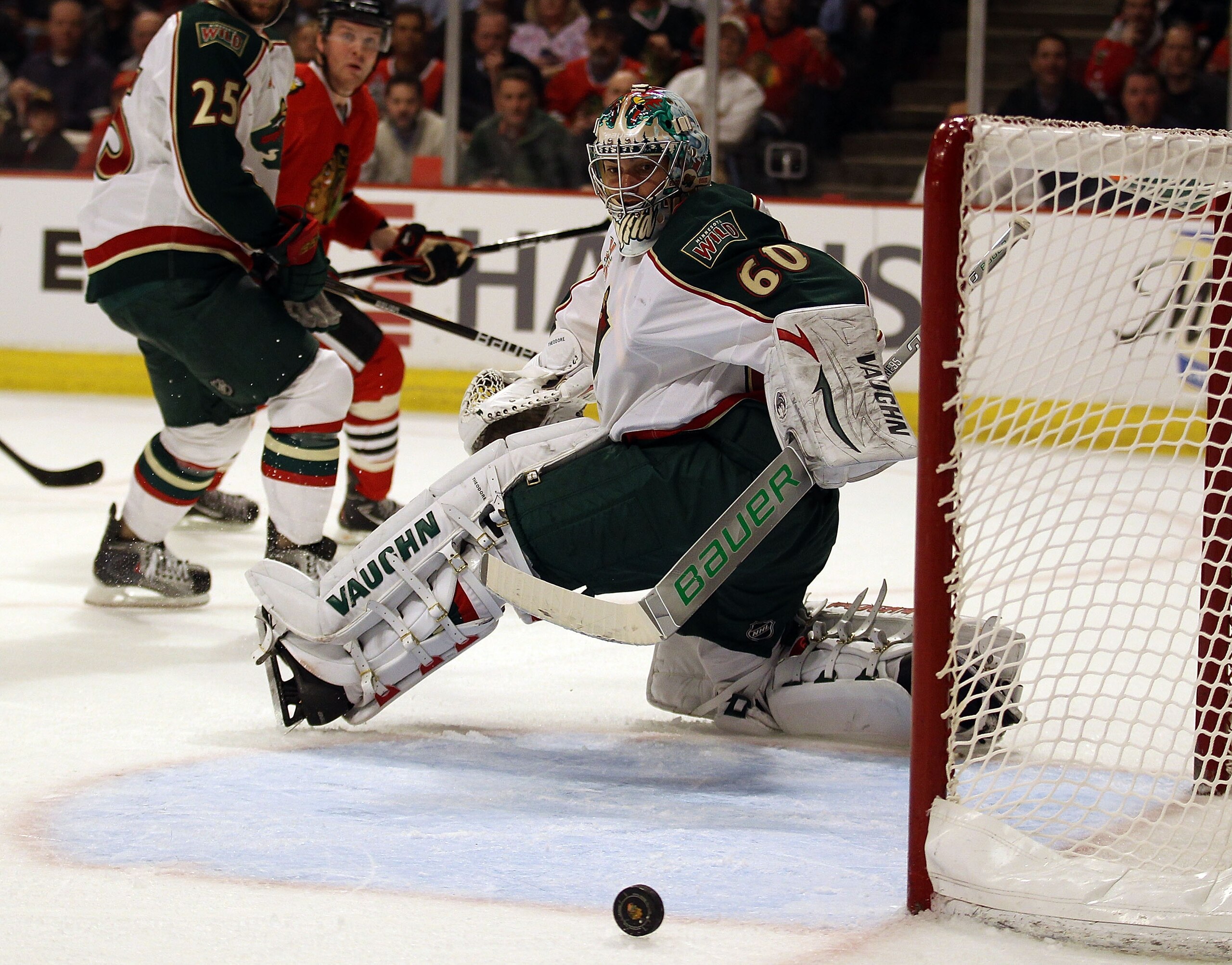 CHICAGO, IL - FEBRUARY 16: Jose Theodore #60 of the Minnesota Wild knocks the puck away for a save against the Chicago Blackhawks at the United Center on February 16, 2011 in Chicago, Illinois. The Blackhawks defeated the Wild 3-1. (Photo by Jonathan Dani CHICAGO, IL - FEBRUARY 16: Jose Theodore #60 of the Minnesota Wild knocks the puck away for a save against the Chicago Blackhawks at the United Center on February 16, 2011 in Chicago, Illinois. The Blackhawks defeated the Wild 3-1. (Photo by Jonathan Dani