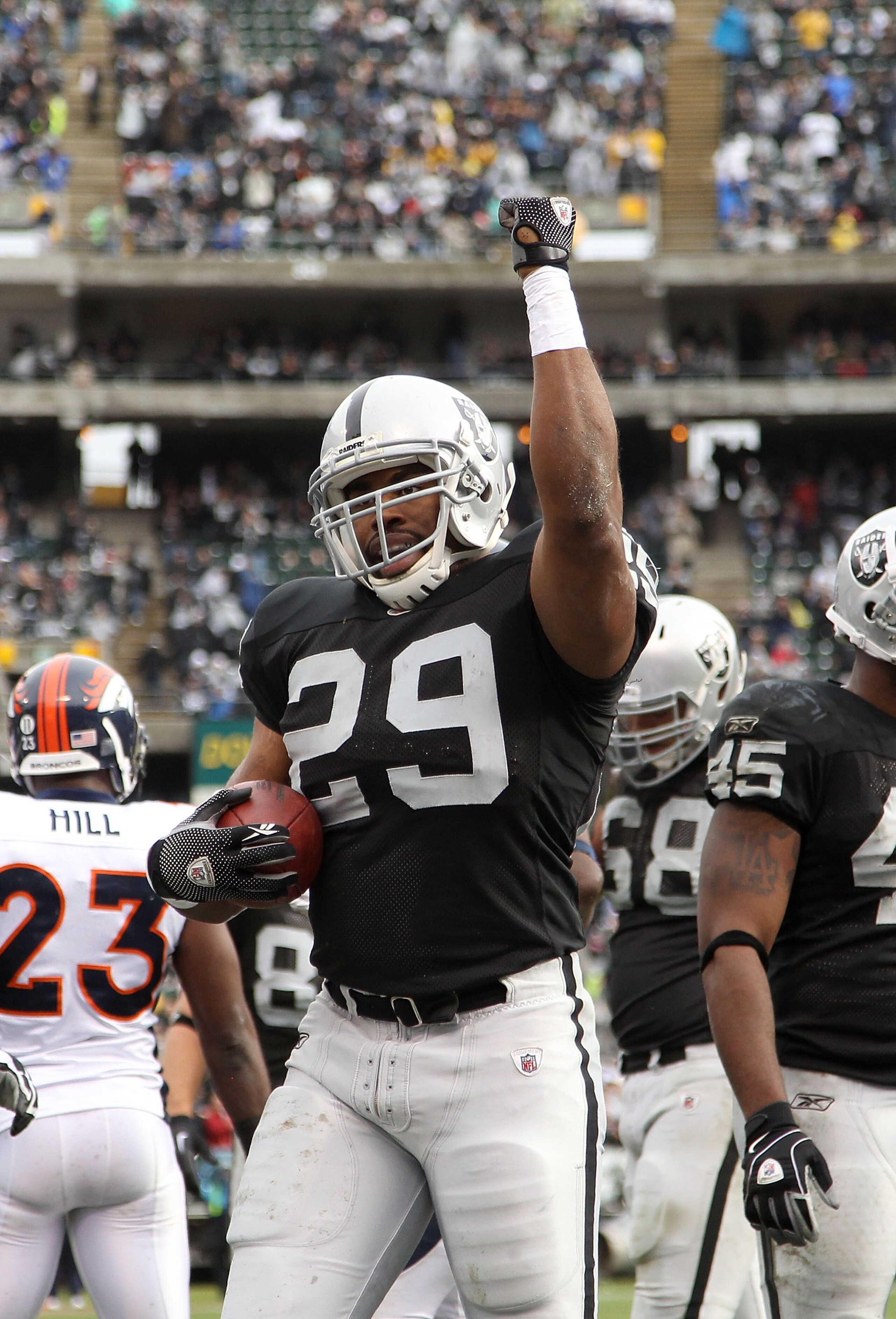 OAKLAND, CA - DECEMBER 19:  Michael Bush #29 of the Oakland Raiders celebrates after he scored a touchdown against the Denver Broncos at Oakland-Alameda County Coliseum on December 19, 2010 in Oakland, California.  (Photo by Ezra Shaw/Getty Images)