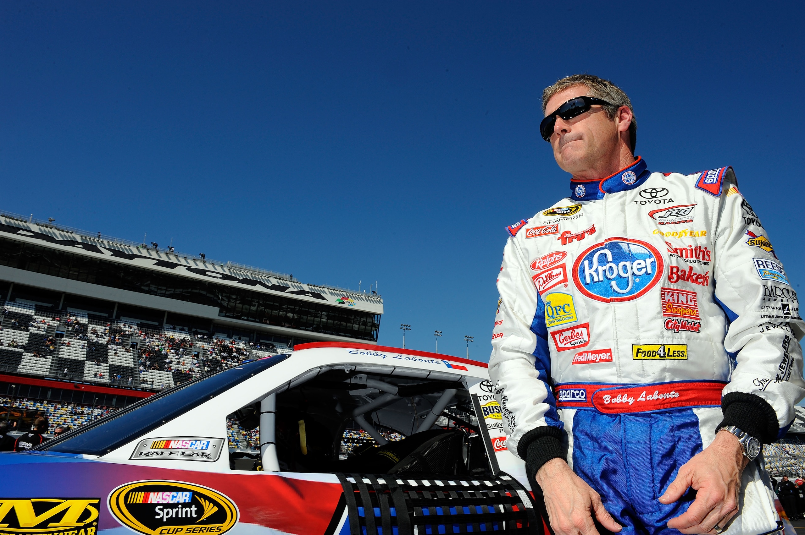 DAYTONA BEACH, FL - FEBRUARY 13:  Bobby Labonte, driver of the #47 Kroger/USO Toyota, stands on the grid during qualifying for the NASCAR Sprint Cup Series Daytona 500 at Daytona International Speedway on February 13, 2011 in Daytona Beach, Florida.  (Pho