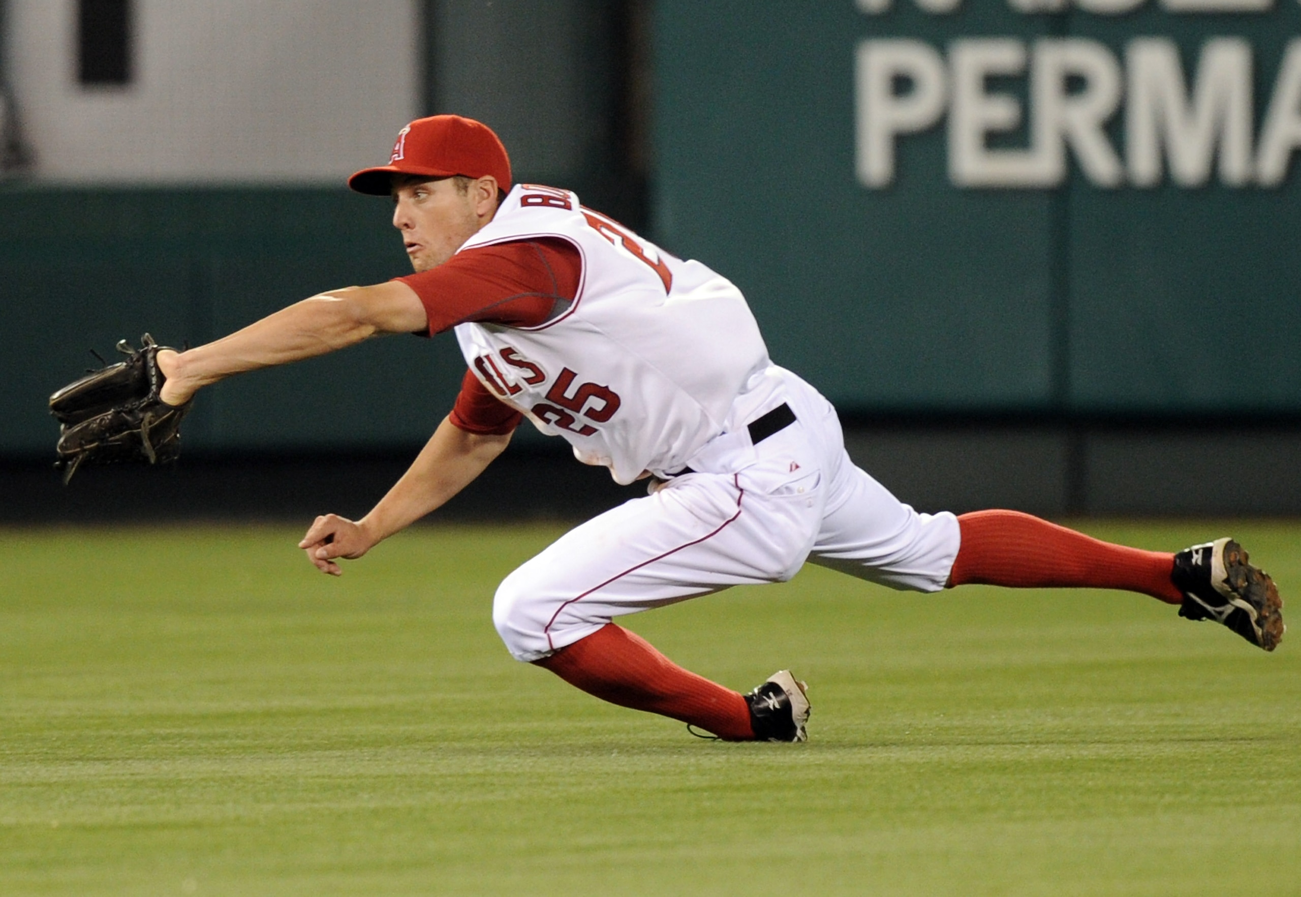 ANAHEIM, CA - AUGUST 13: Peter Bourjos #25 of the Los Angeles Angels makes a diving catch for an out of Aaron Hill #2 of the Toronto Blue Jays during the fourth inning at Angel Stadium on August 13, 2010 in Anaheim, California.  (Photo by Harry How/Getty
