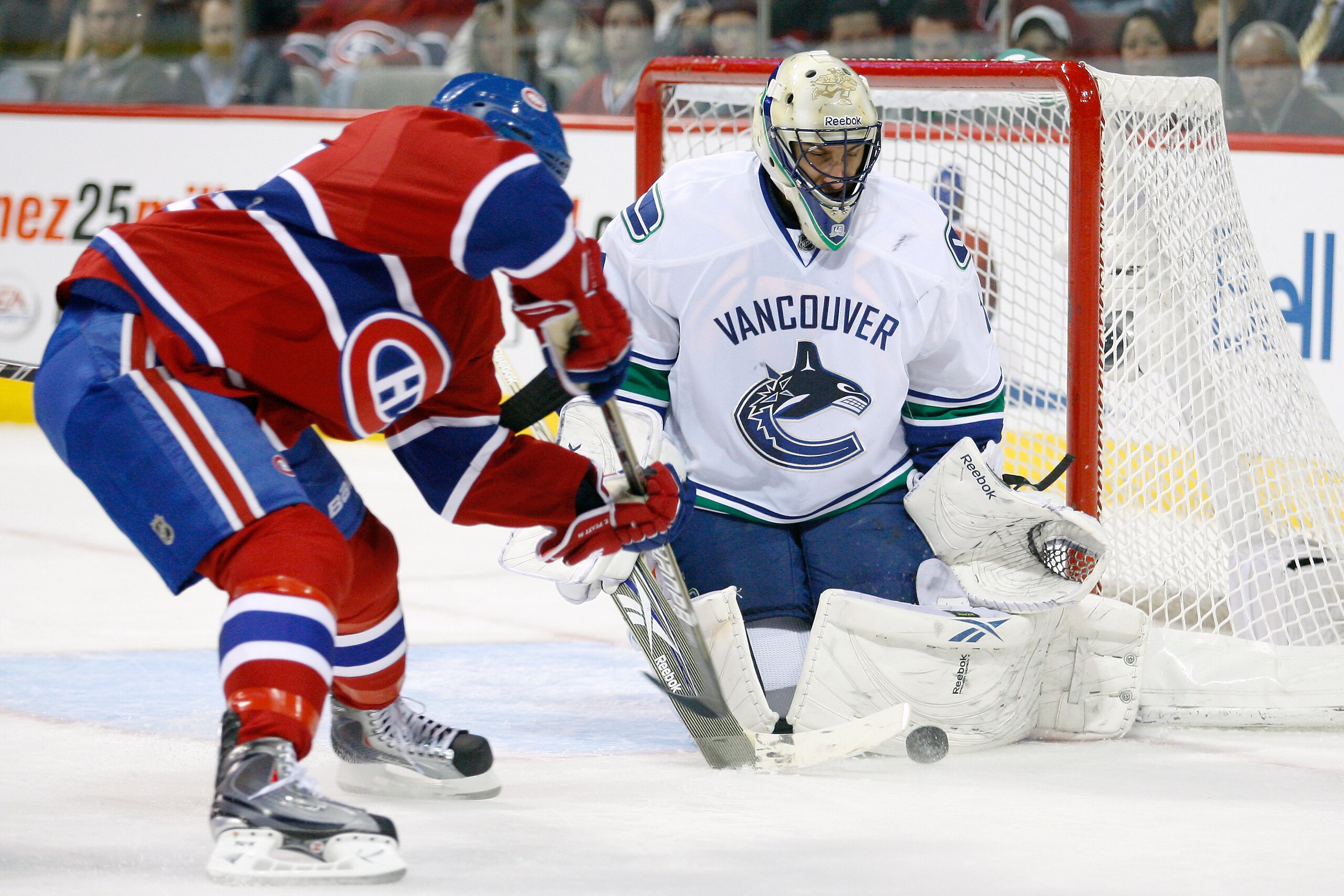 MONTREAL - NOVEMBER 9:  Roberto Luongo #1 of the Vancouver Canucks stops the puck on a shot by Tom Pyatt #94 of the Montreal Canadiens during the NHL game at the Bell Centre on November 9, 2010 in Montreal, Quebec, Canada.  (Photo by Richard Wolowicz/Gett