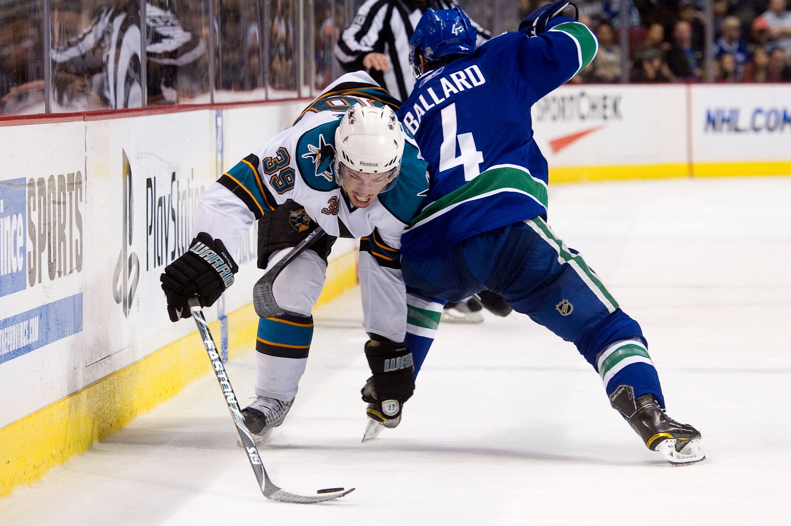VANCOUVER, CANADA - JANUARY 20: Logan Couture #39 of the San Jose Sharks tries to get past Keith Ballard #4 of the Vancouver Canucks during the third period in NHL action on January 20, 2011 at Rogers Arena in Vancouver, BC, Canada.  (Photo by Rich Lam/Ge