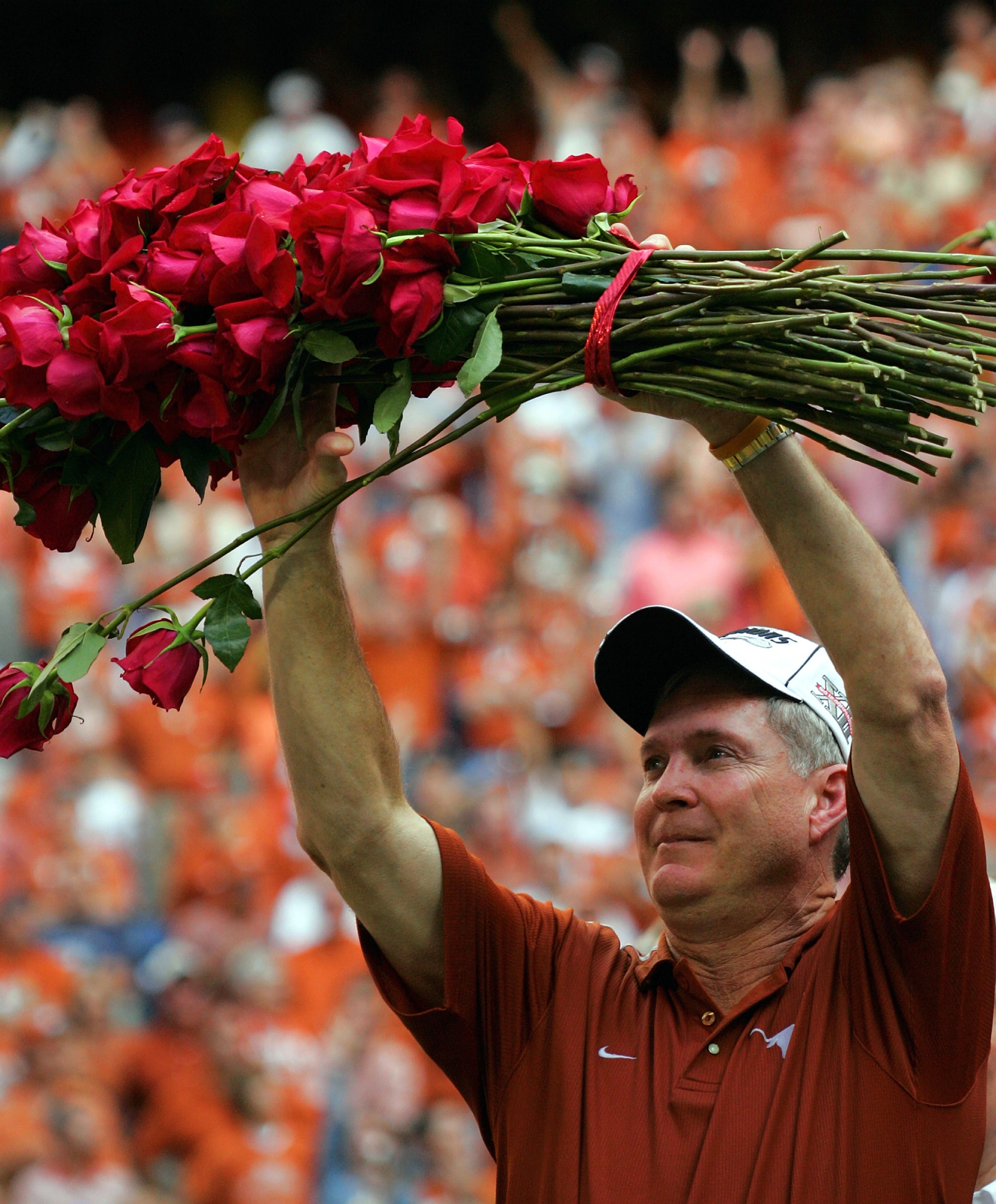 HOUSTON - DECEMBER 3: Head coach Mack Brown of the Texas Longhorns holds up roses after a 70-3 win against the Colorado Buffaloes during the Dr. Pepper Big 12 Championship on December 3, 2005 at Reliant Stadium in Houston, Texas. (Photo by Ronald Martin HOUSTON - DECEMBER 3: Head coach Mack Brown of the Texas Longhorns holds up roses after a 70-3 win against the Colorado Buffaloes during the Dr. Pepper Big 12 Championship on December 3, 2005 at Reliant Stadium in Houston, Texas. (Photo by Ronald Martin