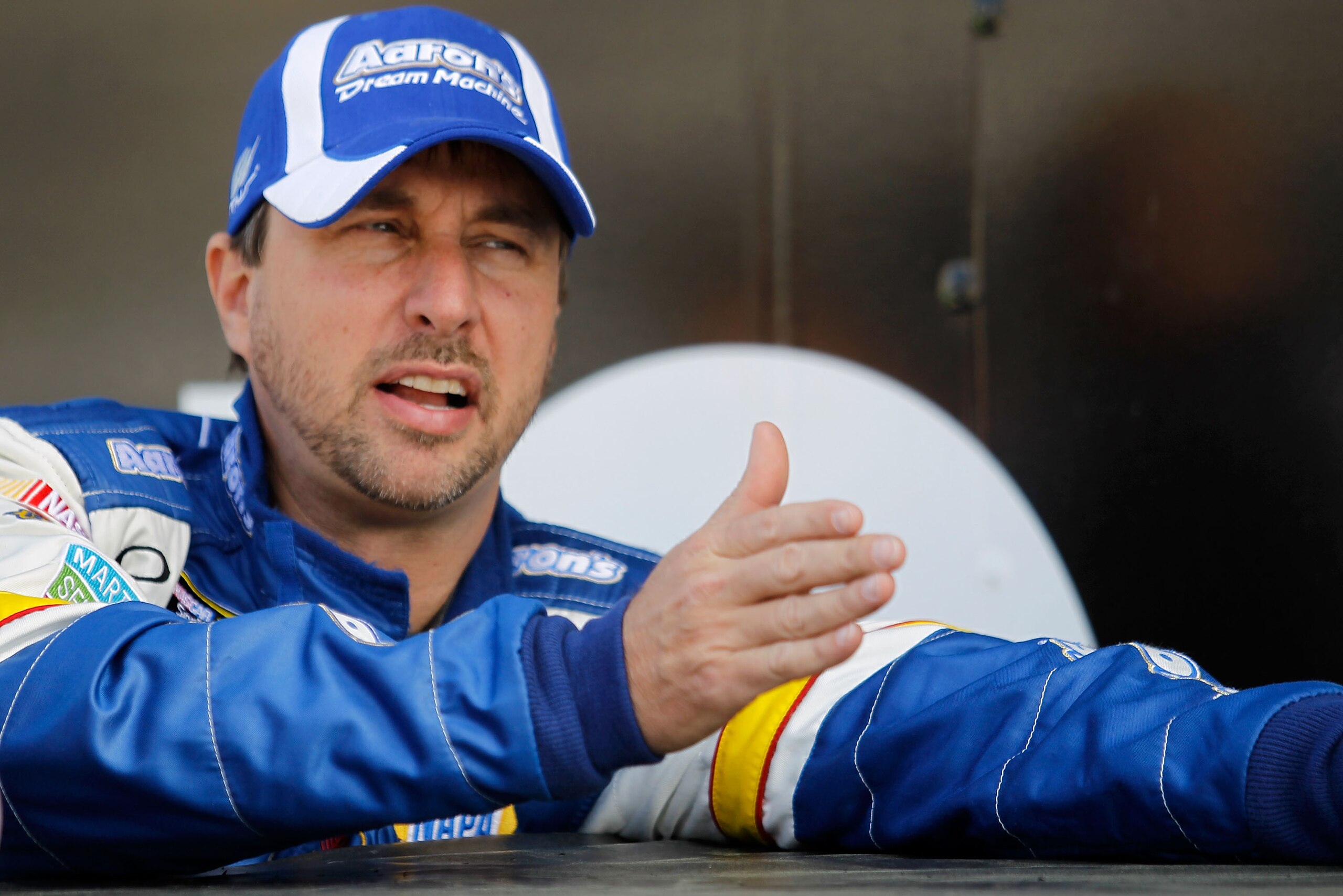 DAYTONA BEACH, FL - FEBRUARY 12:  David Reutimann, driver of the #00 Aaron's Dream Machine Toyota, stands in the garage area during practice for the NASCAR Sprint Cup Series Daytona 500 at Daytona International Speedway on February 12, 2011 in Daytona Bea