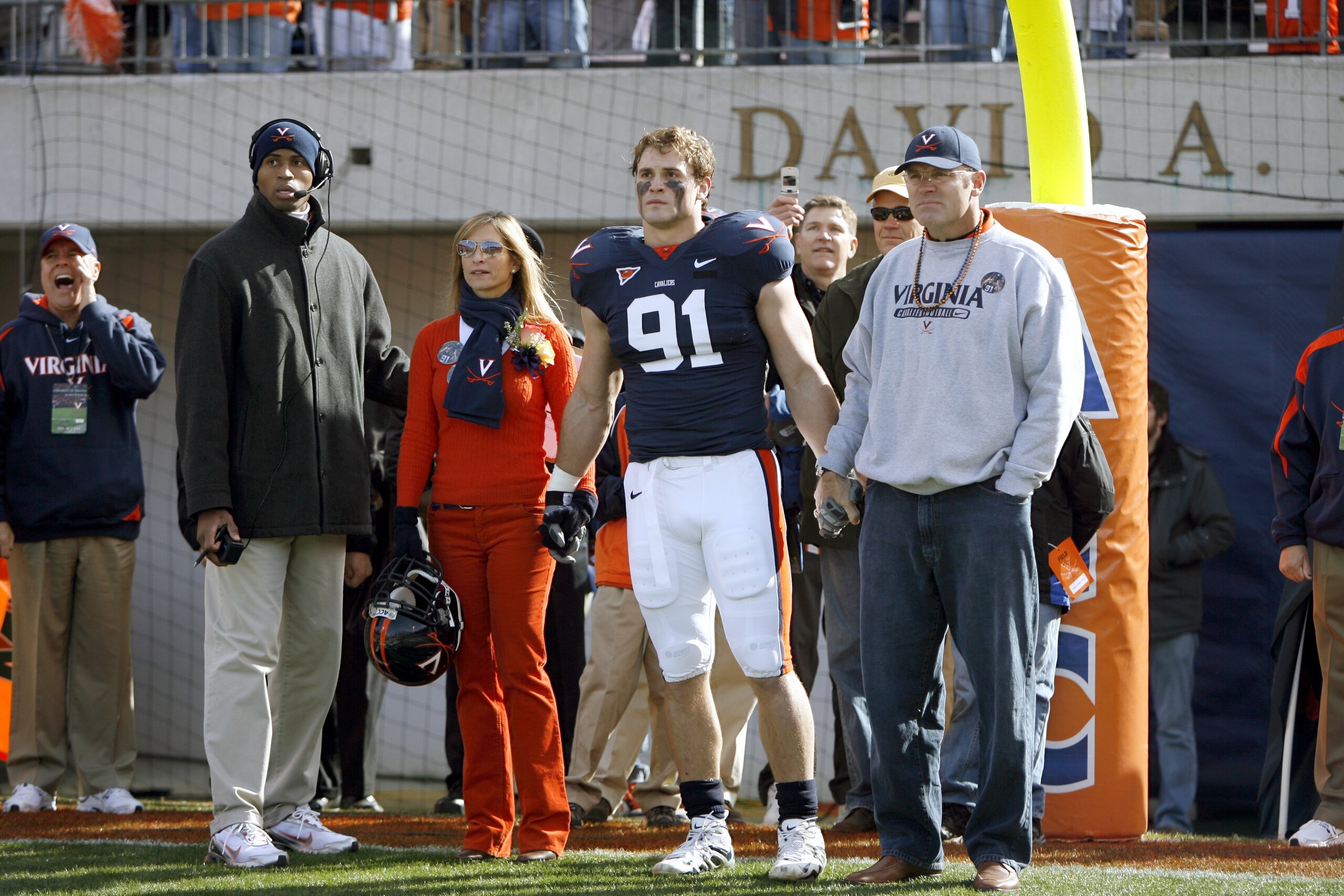 CHARLOTTESVILLE, VA - NOVEMBER 24: Defensive end Chris Long #91 of the Virginia Cavaliers stands with his mother Diane and his father and Pro Football Hall of Famer Howie Long before Chris' jersey retirement during pregame of their matchup against the Vir