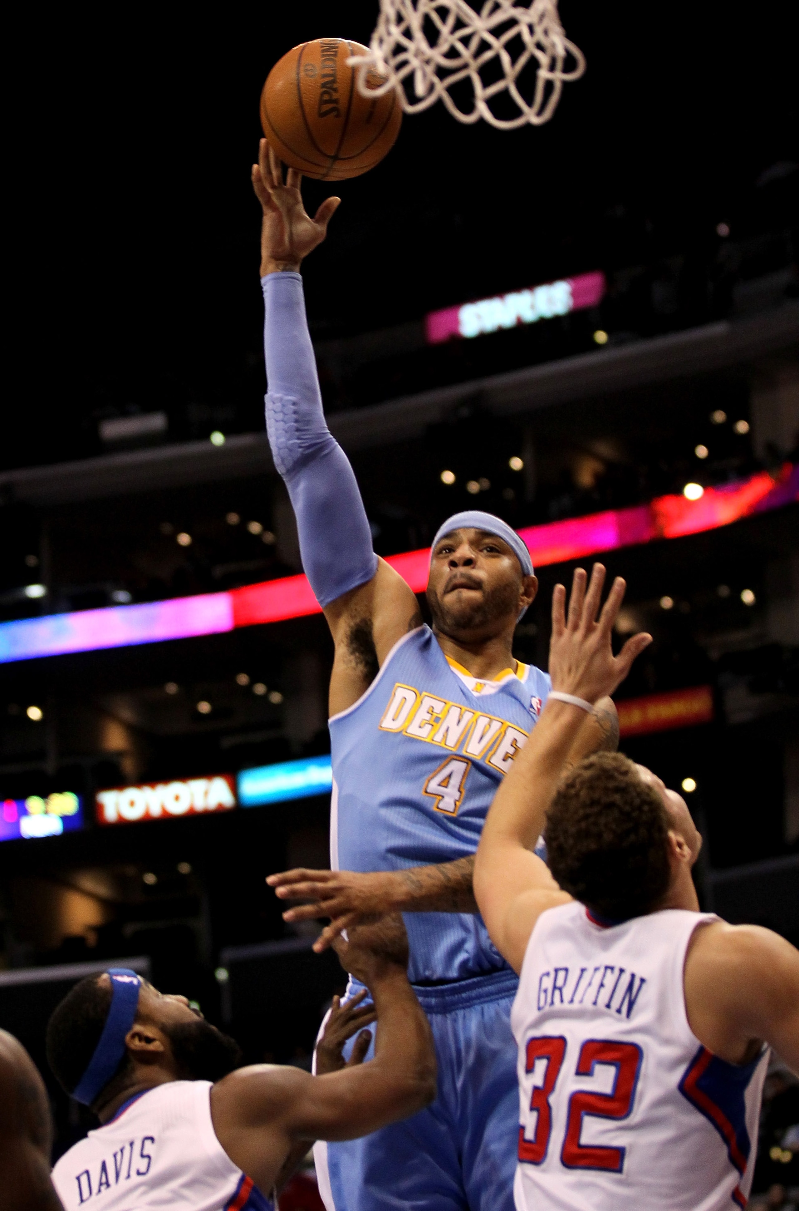 LOS ANGELES, CA - JANUARY 05:  Carmelo Anthony #15 of the Denver Nuggets shoots over Baron Davis #5 and Blake Griffin #32 of the Los Angeles Clippers at Staples Center on January 5, 2011  in Los Angeles, California.  NOTE TO USER: User expressly acknowled