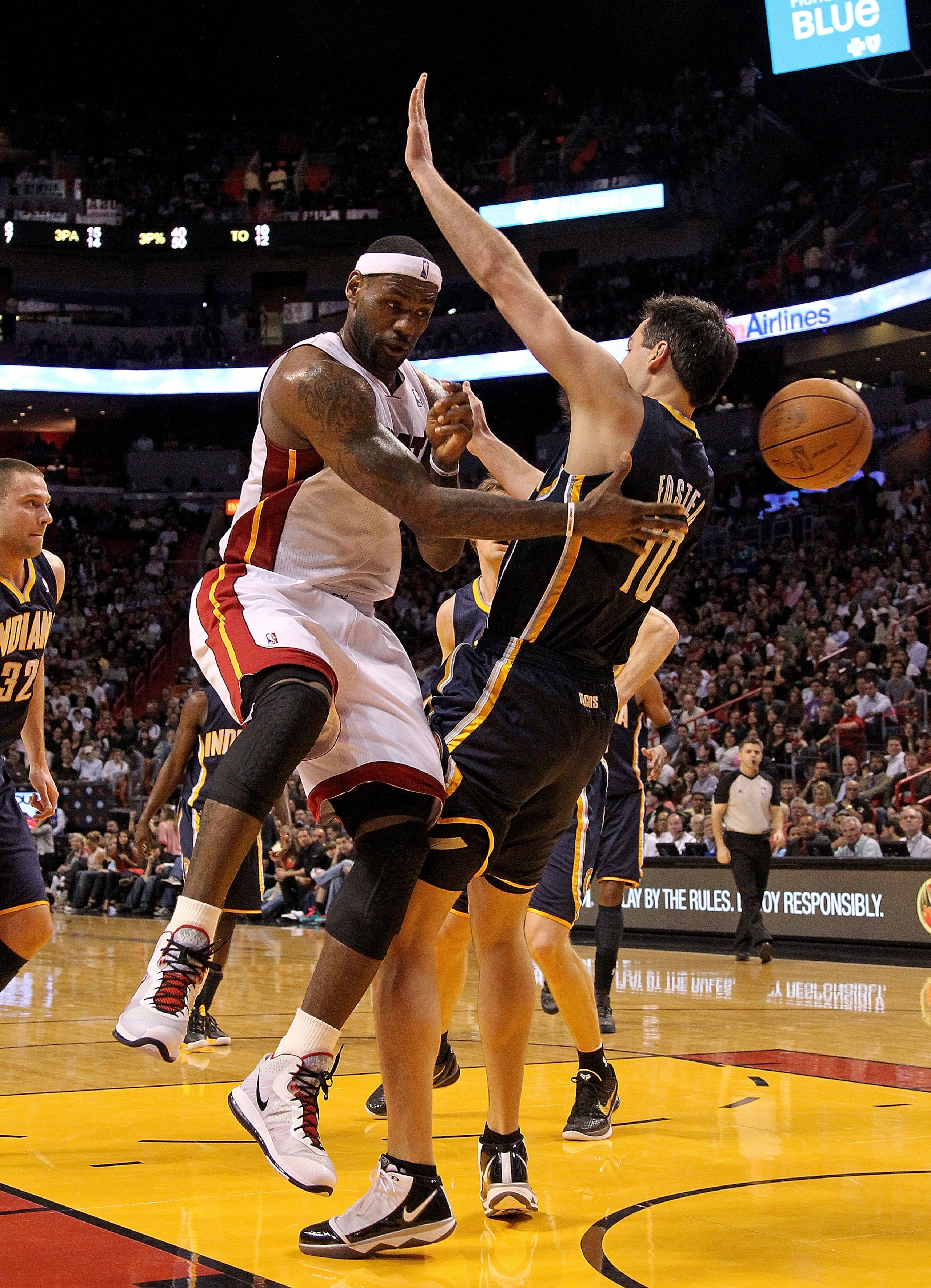 MIAMI, FL - FEBRUARY 08:  LeBron James #6 of the Miami Heat passes around Jeff Foster #10 of the Indiana Pacers during a game at American Airlines Arena on February 8, 2011 in Miami, Florida. NOTE TO USER: User expressly acknowledges and agrees that, by d