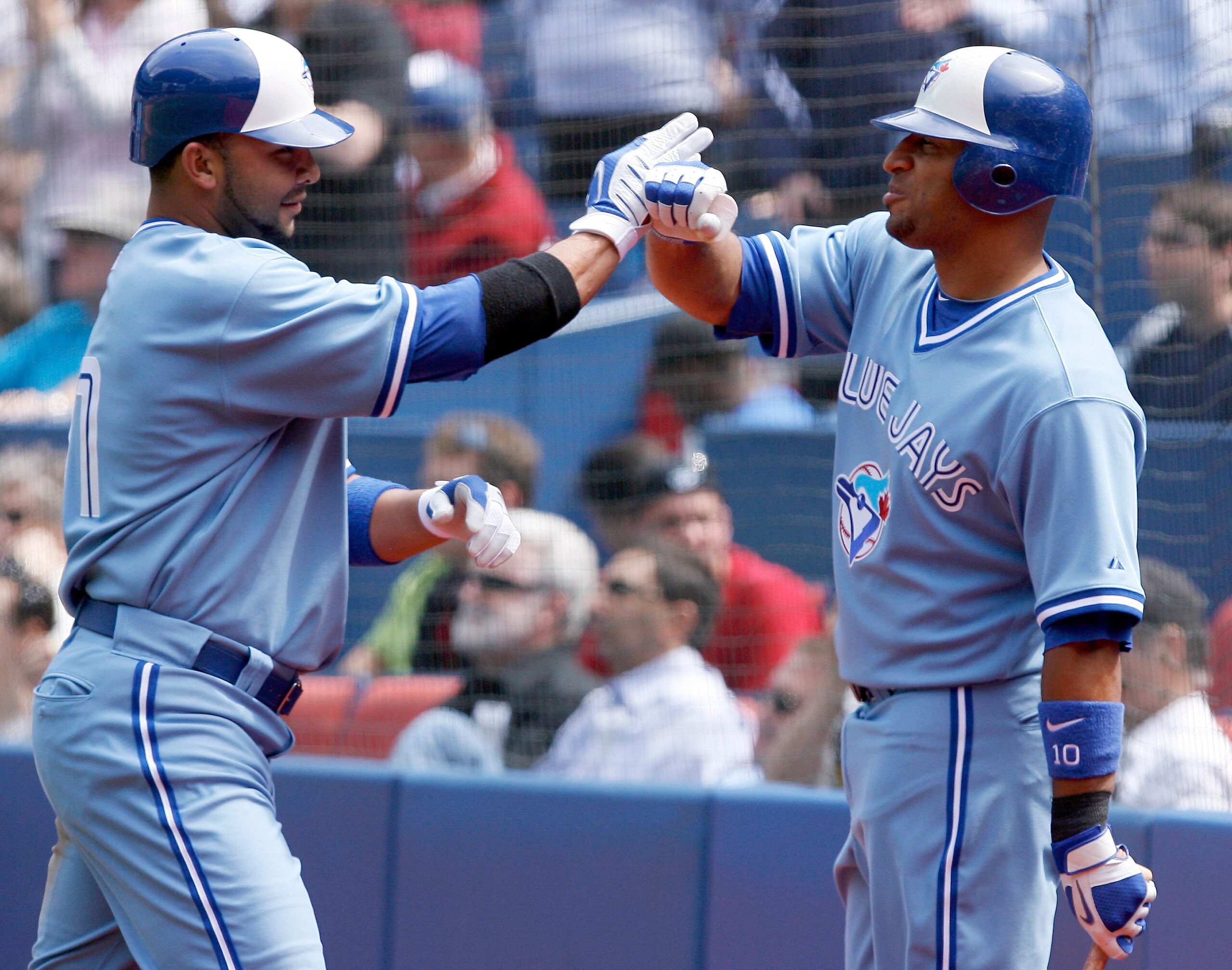 TORONTO - APRIL 21: Alex Gonzalez #11 and Vernon Wells #10 of the Toronto Blue Jays celebrate Gonzalez's run against the Kansas City Royals during a MLB game at the Rogers Centre April 21, 2010 in Toronto, Ontario, Canada. (Photo by Abelimages / Getty Ima
