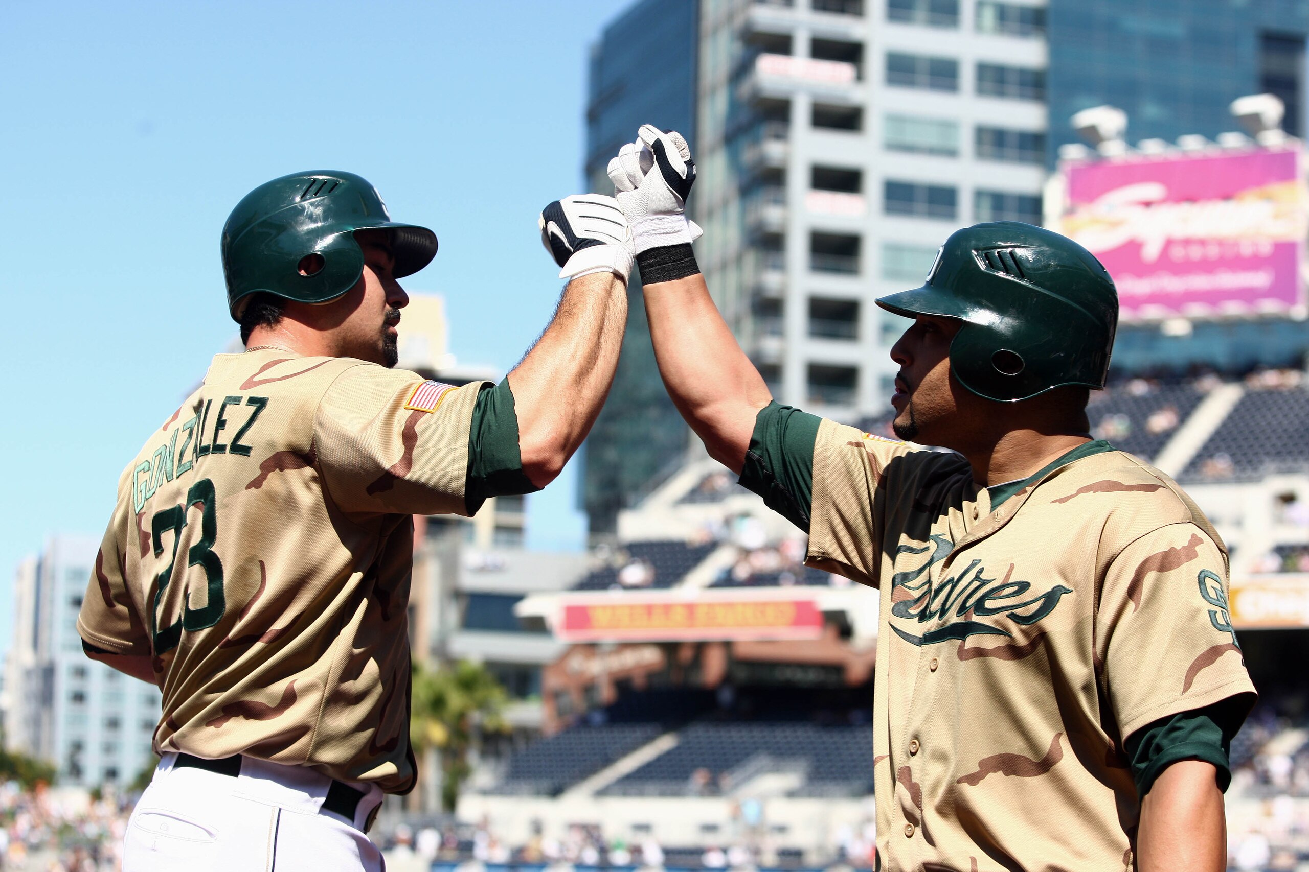 SAN DIEGO, CA - SEPTEMBER 26:  Adrian Gonzalez #23 of the San Diego Padres is congratulated by teammate Yorvit Torrealba #8 after Gonzalez hit a solo home run in the bottom of the 2nd inning against  the Cincinnati Reds during their MLB game on September