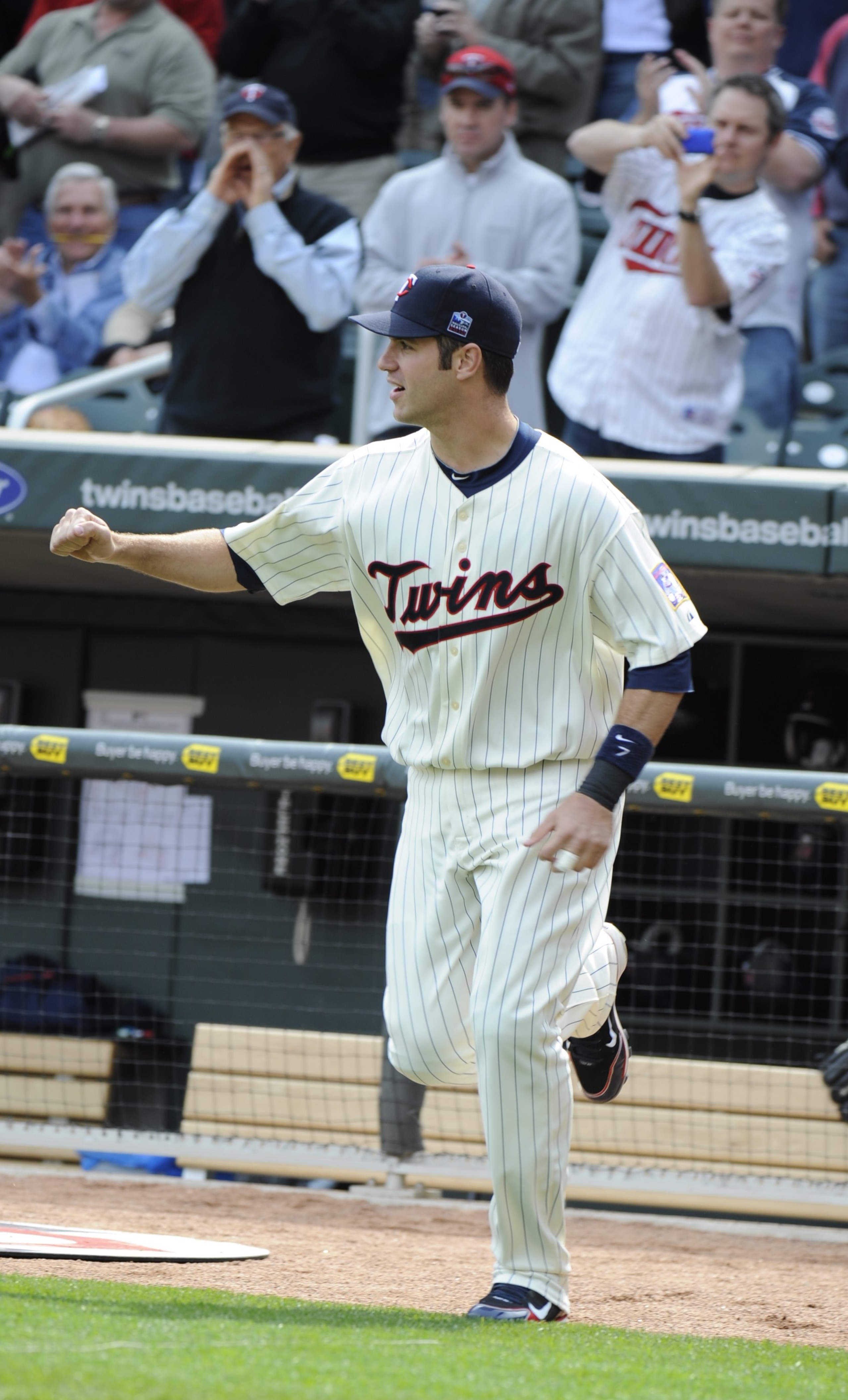 MINNEAPOLIS, MN - APRIL 12: Joe Mauer #7 of the Minnesota Twins runs onto the field as he is announced prior to a game against the Boston Red Sox during the Twins home opener at Target Field on April 12, 2010 in Minneapolis, Minnesota. (Photo by Hannah Fo