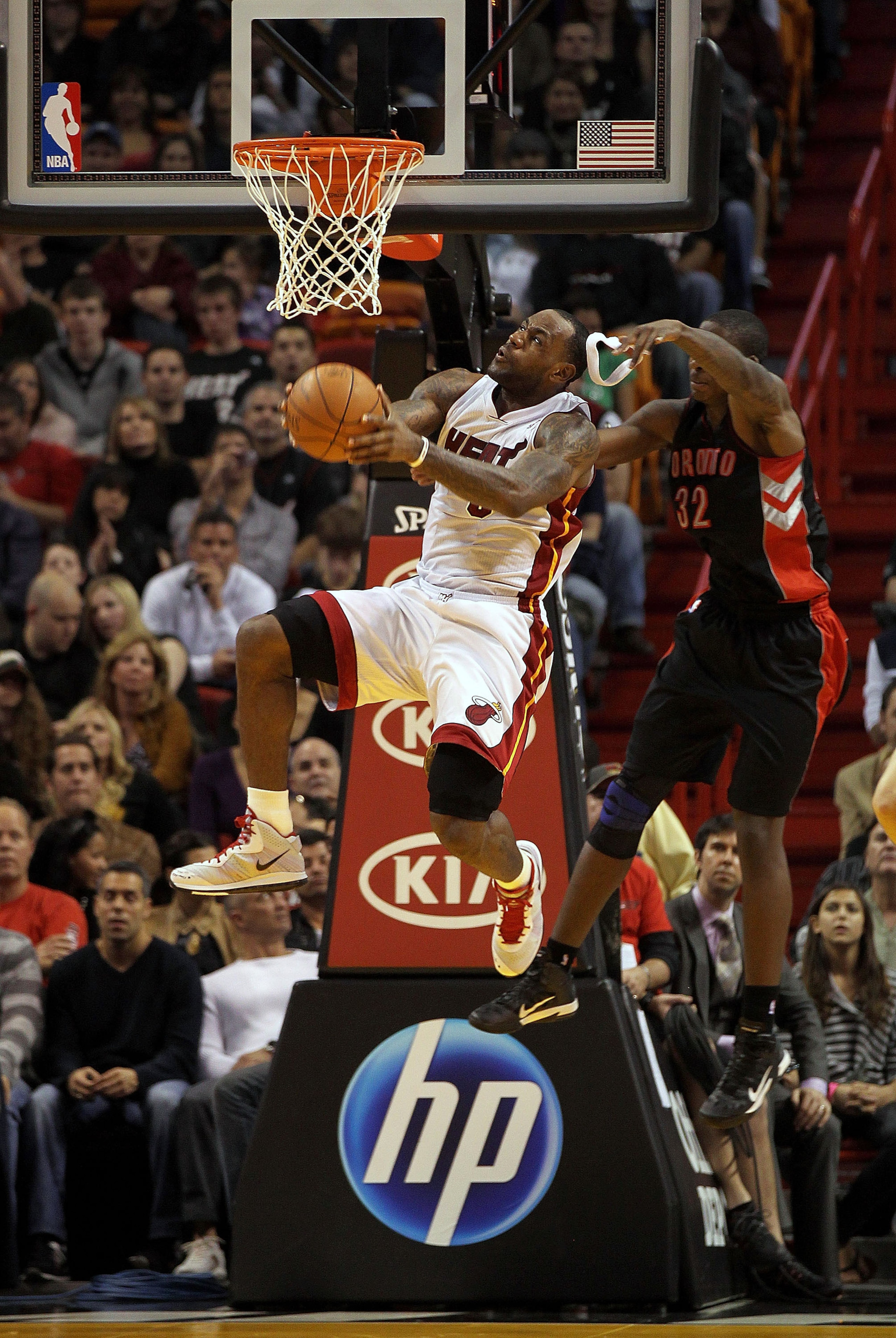 MIAMI, FL - JANUARY 22:  LeBron James #6 of the Miami Heat is fouled by Ed Davis #32 of the Toronto Raptors during a game  at American Airlines Arena on January 22, 2011 in Miami, Florida. NOTE TO USER: User expressly acknowledges and agrees that, by down