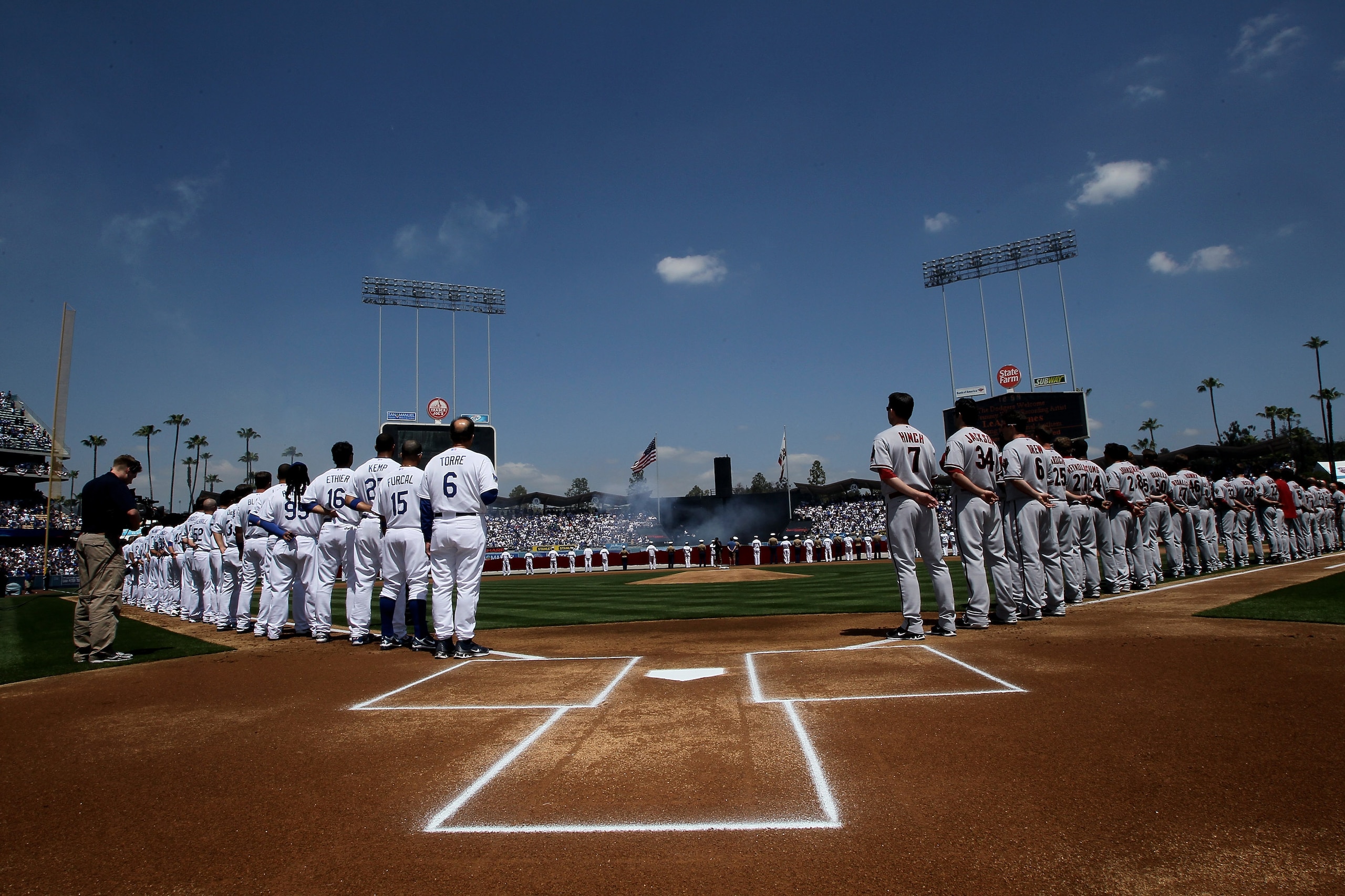 LOS ANGELES, CA - APRIL 13:  The Arizona Diamondbacks and the Los Angeles Dodgers stand on the field for the national anthem during opening day ceremonies on April 13, 2010 at Dodger Stadium in Los Angeles, California.  (Photo by Stephen Dunn/Getty Images