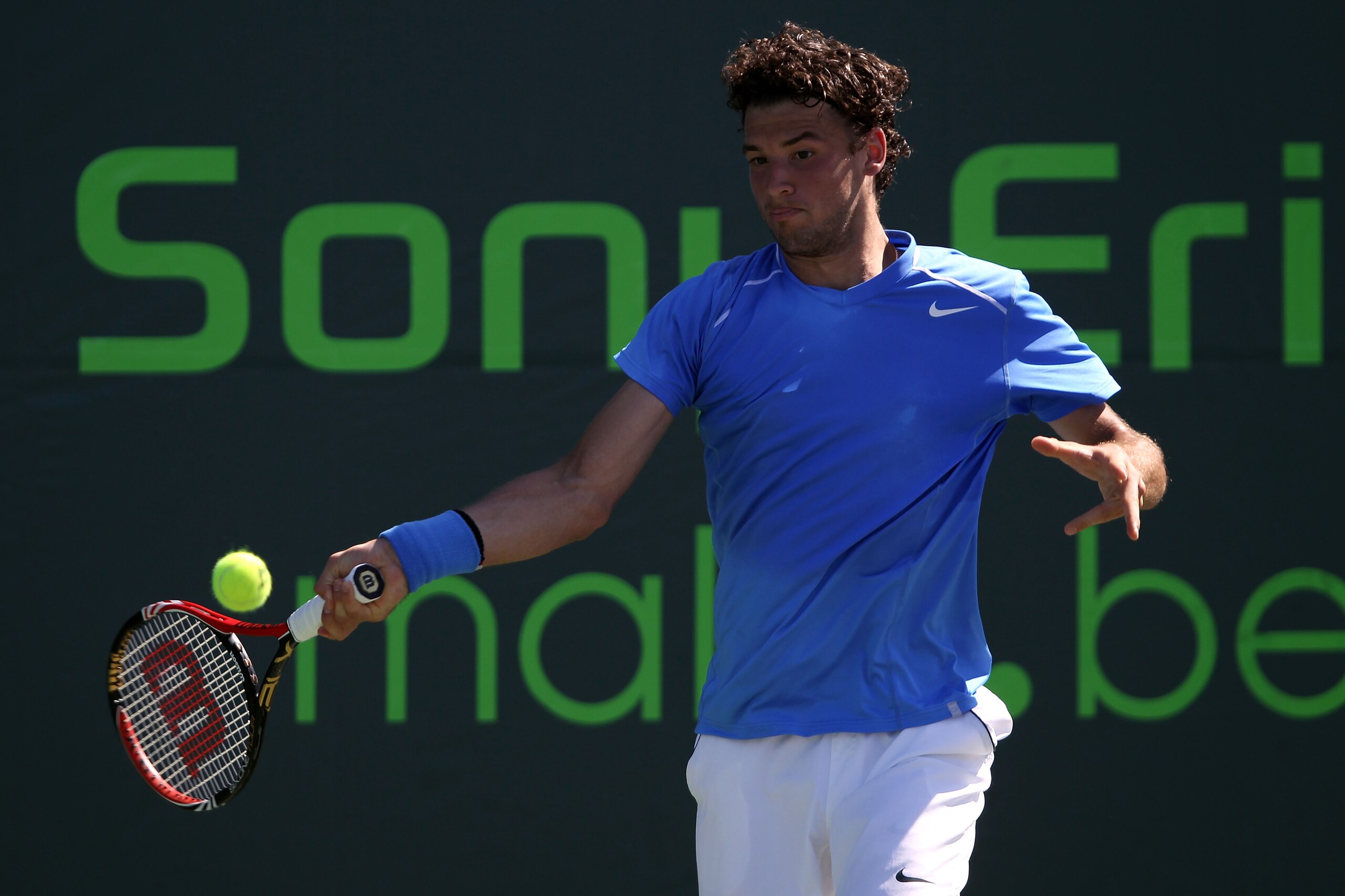 KEY BISCAYNE, FL - MARCH 24:  Grigor Dimitrov of Bulgaria hits a forehand return against Sergiy Stakhovsky of the Ukraine during the Sony Ericsson Open at Crandon Park Tennis Center on March 24, 2011 in Key Biscayne, Florida.  (Photo by Clive Brunskill/Ge