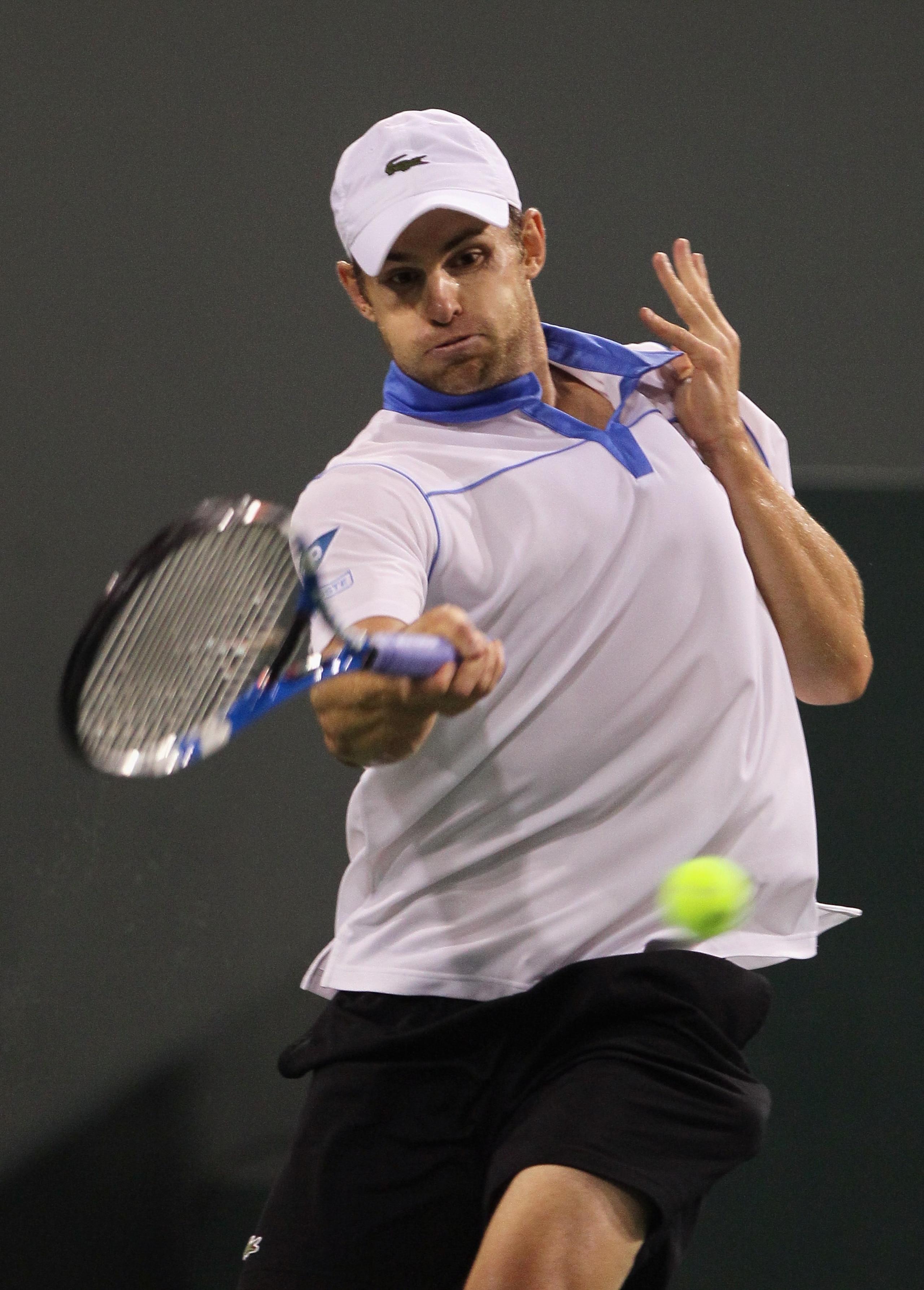 INDIAN WELLS, CA - MARCH 15:  Andy Roddick returns a forehand to John Isner during the BNP Paribas Open at the Indian Wells Tennis Garden on March 15, 2011 in Indian Wells, California.  (Photo by Jeff Gross/Getty Images)